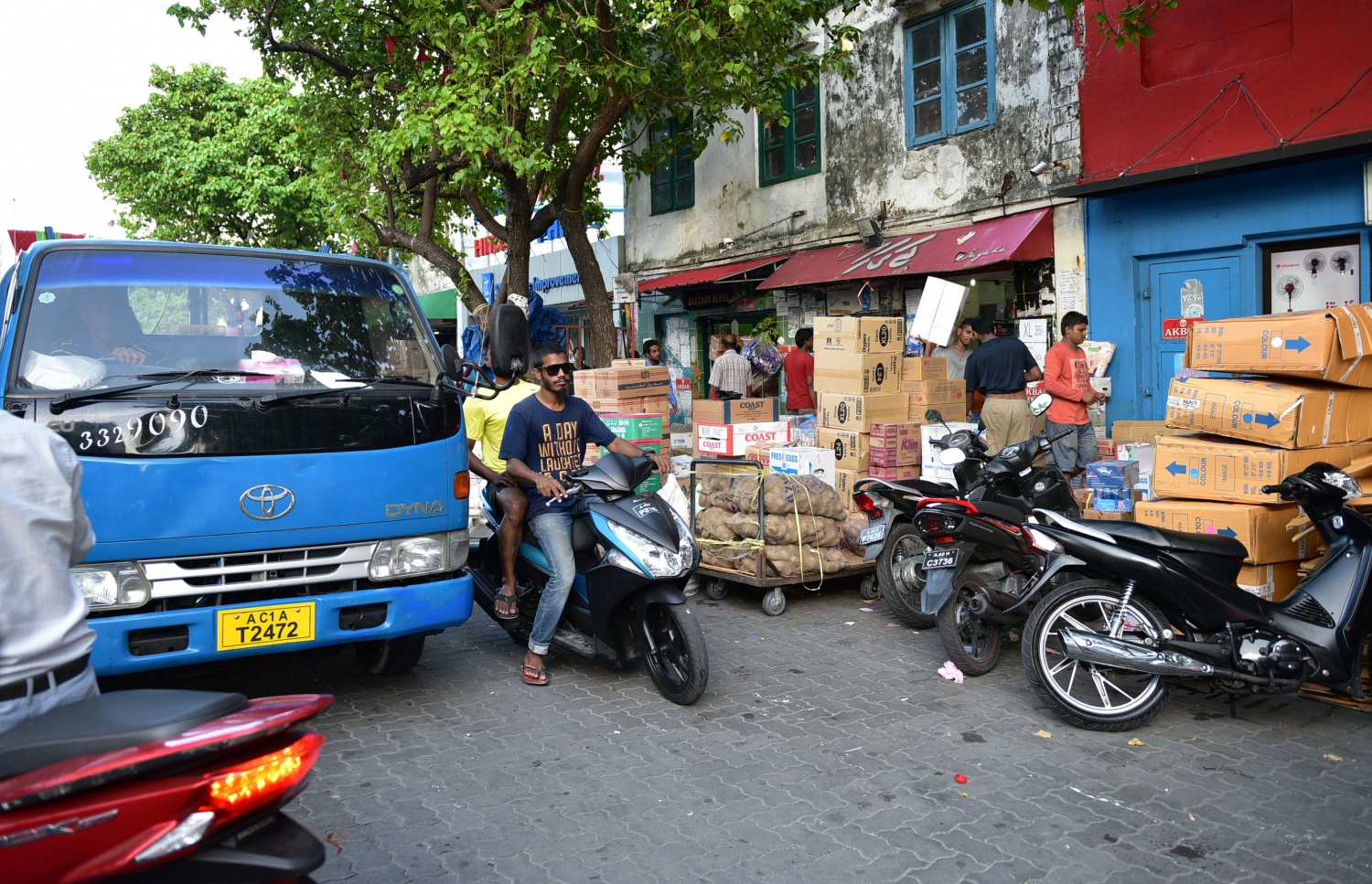 ލޯކަލް މާރުކޭޓް ސަރަހައްދުގައި ހުރި ފިހާރައެއް ކައިރީގައި މުދާ ބަހައްޓާފައި. ބައެއް ވިޔަފާރިވެރިން ވެސް ފިޔާ، އަލުވި، ބިސް ރާއްޖެ އެތެރެކުރޭ -- ފޮޓޯ: މުހައްމަދު ޝަރުހާން / މިހާރު