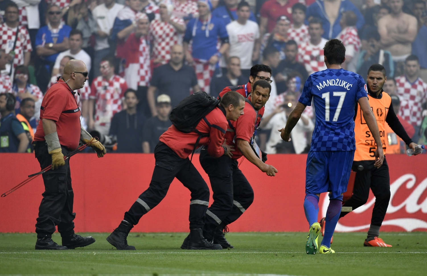 ކްރޮއޭޝިއާ ސަޕޯޓަރުން ދަނޑަށް ފަޓާސް އުކުމުން ސެކިއުރިޓީ އޮފިޝަލުން ދަނޑުން އެ އެއްޗެހި ނަގަނީ.-- ފޮޓޯ: އޭއެފްޕީ