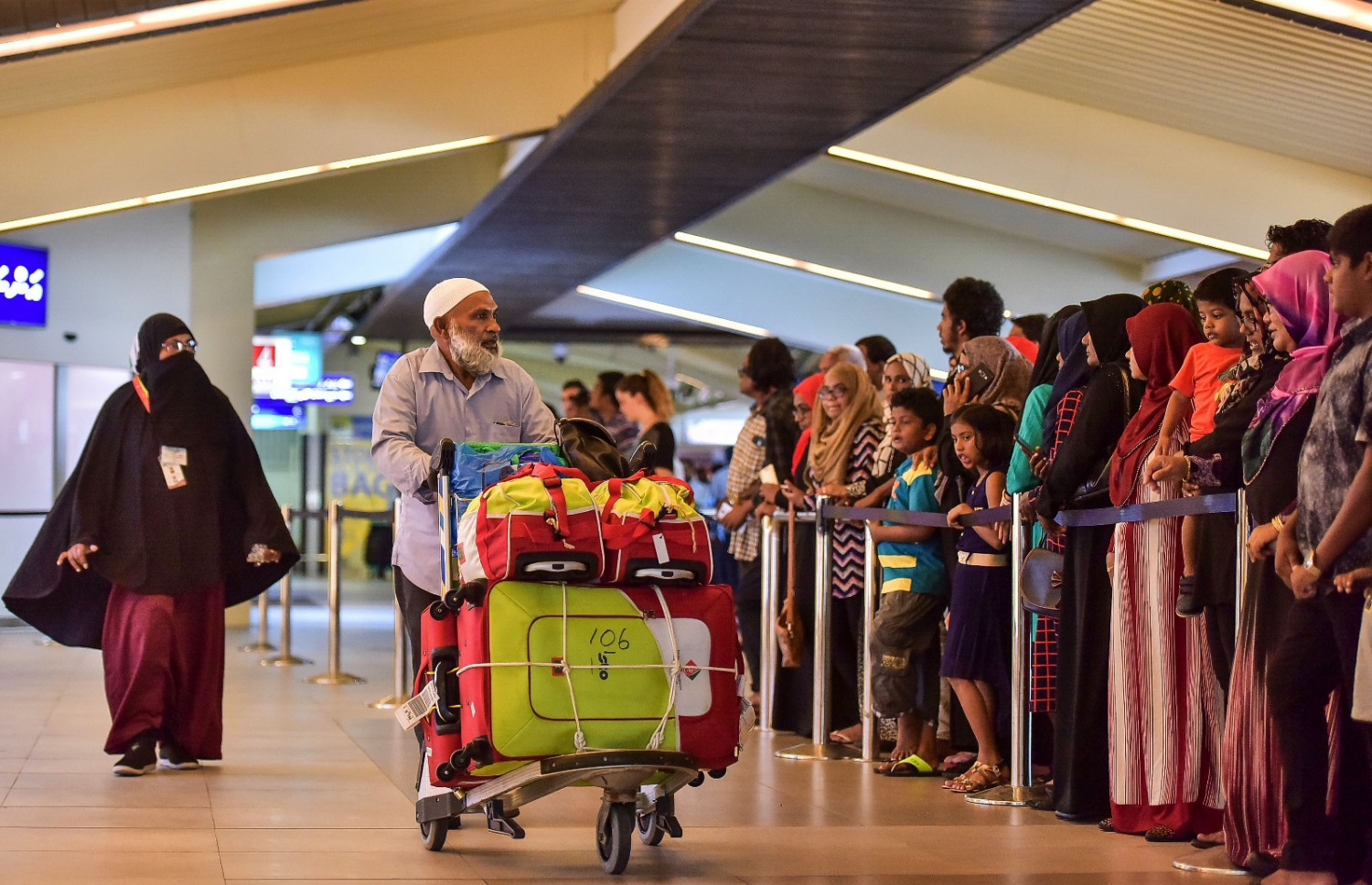 ހުޅުލެ، ސެޕްޓެމްބަރު 17، 2016 - ރާއްޖެއިން ހައްޖަށް ދިޔަ މީހުންގެ ތެރެއިން ރާއްޖެ އައި ފުރަތަމަ ގްރޫޕްގައި ހިމެނުނު ބަޔަކު ޓާމިނަލުން ނިކުމެގެން އަންނައިރު، ހައްޖުވެރިންގެ އާއިލާތަކުގެ މީހުން މަރުހަބާ ކިޔުމަށް އެއާޕޯޓަށް ޖަމާވެފައި. އެންމެ ފުރަތަމަ އައީ ހައްޖު ކޯޕަރޭޝަންގެ ހަވާލުގައި ހައްޖަށް ދިޔަ މީހުންގެ ތެރެއިން 252 މީހަކު. -- ފޮޓޯ: ނިޝާން އަލީ/މިހާރު