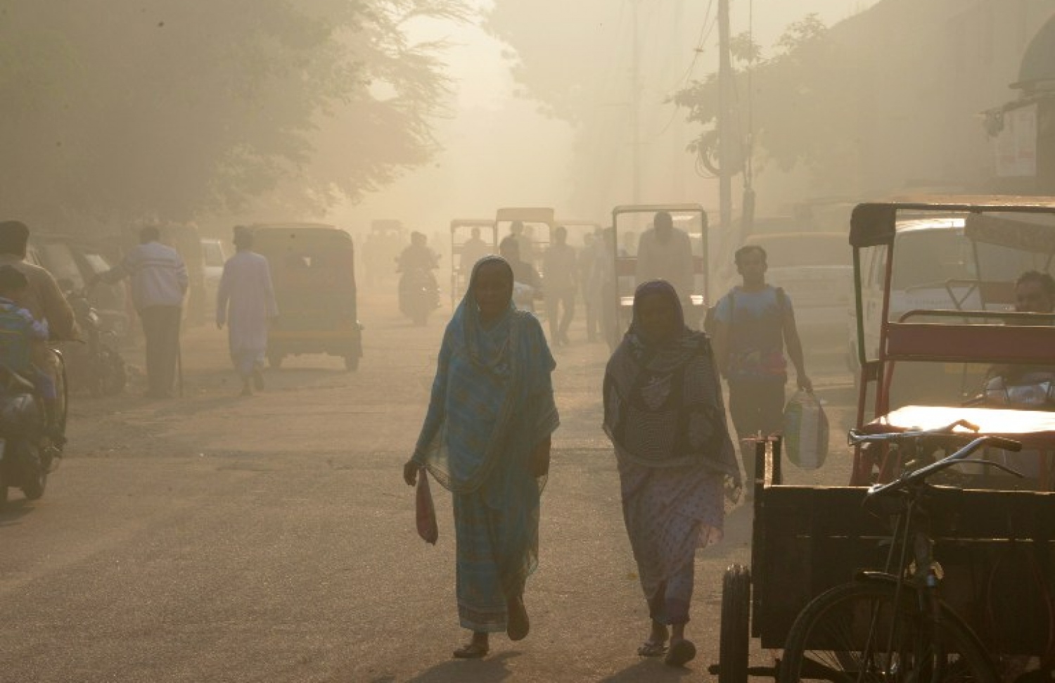 ދުން ބޯވެފައިވާ ދިއްލީގެ މަގެއްގައި ބަޔަކު ހިނގާލާފައި ދަނީ. --ފޮޓޯ:އޭއެފްޕީ