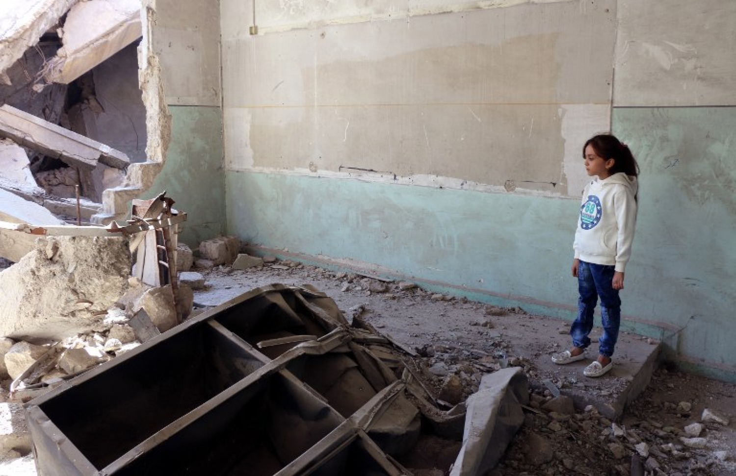 ހަލަބުން ޓްވީޓް ކުރާ ހަތް އަހަރުގެ އަންހެން ކުއްޖާ ހަލާކުވެފައިވާ އިމާރާތަކަށް ބަލަހައްޓައިގެން. --ފޮޓޯ:އޭއެފްޕީ