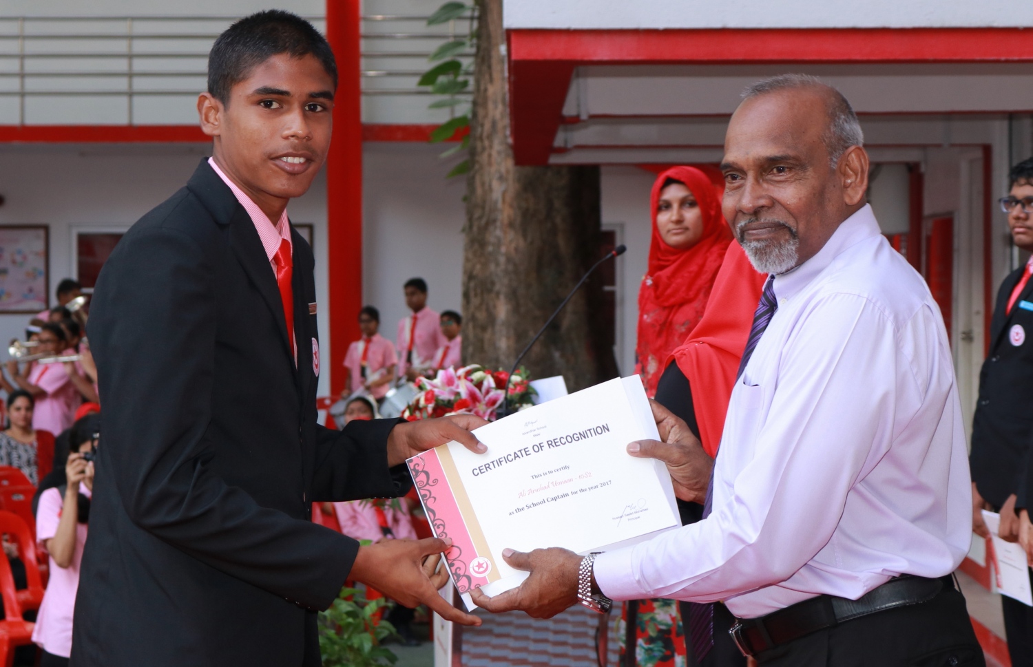 މާލެ: ފެބްރުއަރީ 28، 2017- އިސްކަންދަރު ސްކޫލުގެ ޕްރިފެކްޓް ބޯޑާއި ކްލަބުތަކުގެ މަގާމުތަކަށް ހޮވުނު ދަރިވަރުން ހުވާކުރުމަށް ބޭއްވި ރަސްމިއްޔާތުގައި އެޑިއުކޭޝަން މިނިސްޓްރީގެ ސީނިއާ ޕޮލިސީ އެގްޒެކްޓިވް އިބްރާހިމް އިސްމައިލް (ކ)، ދަރިވަރަކަށް ސެޓިފިކެޓް ހަވާލު ކޮށްދެއްވަނީ.---ފޮޓޯ: އިސްކަންދަރު ސްކޫލް