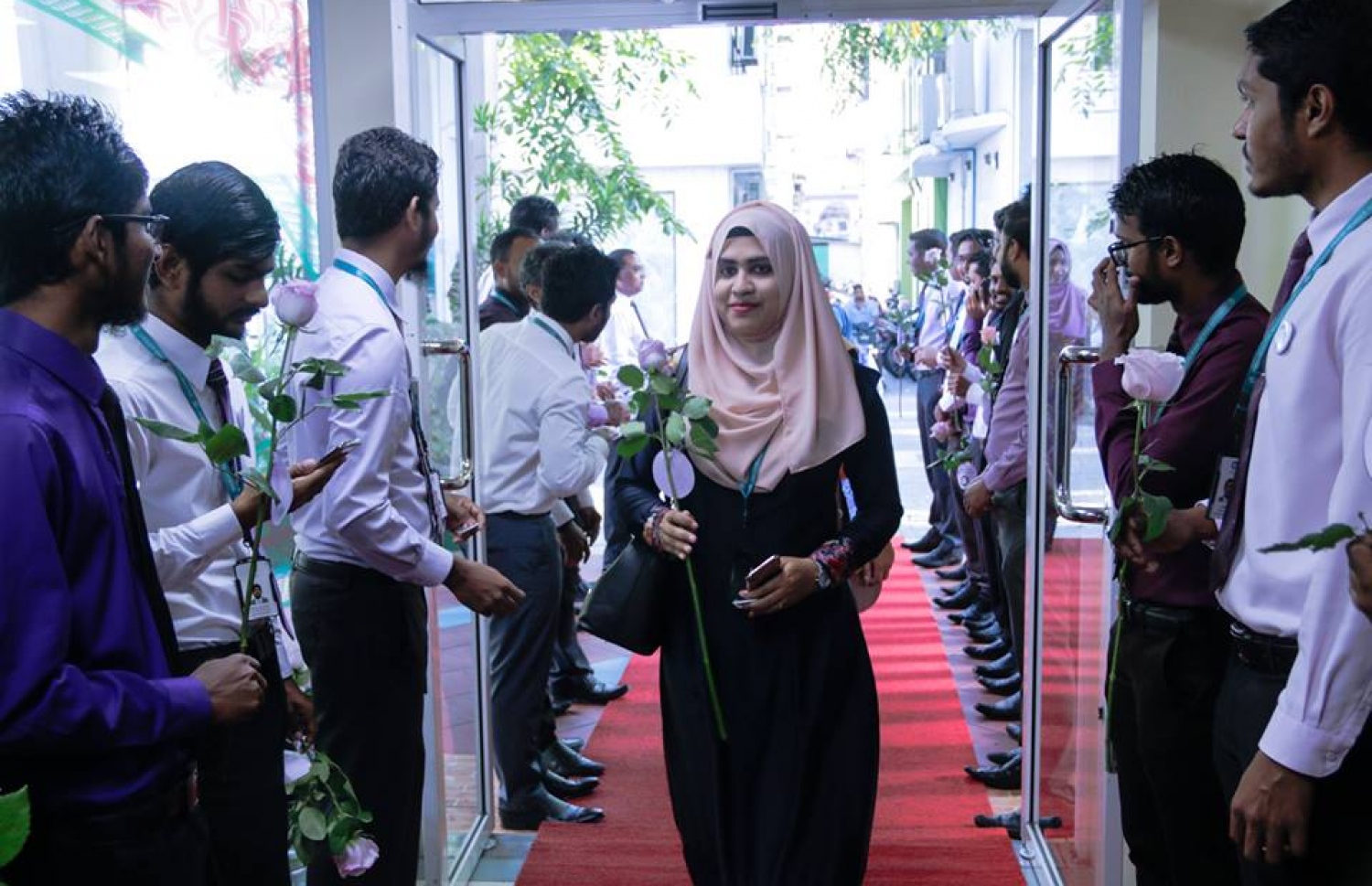 މާލެ: މާޗް 8، 2017: ބައިނަލް އަގްވާމީ އަންހެނުންގެ ދުވަސް ފާހަގަ ކުރުމުގެ ގޮތުން މޯލްޑިވްސް އިންލެންޑް ރެވެނިއު އޮތޯރިޓީ (މީރާ)ގެ އަންހެން މުވައްޒަފުން ގައުމީ ހެދުމުގައި އޮފީހަށް ވަންނަ އިރު، ފިރިހެން މުވައްޒަފުން އެކަނބަލުންނަށް މަރުހަބާ ކިޔަނީ.-- ފޮޓޯ: މީރާ