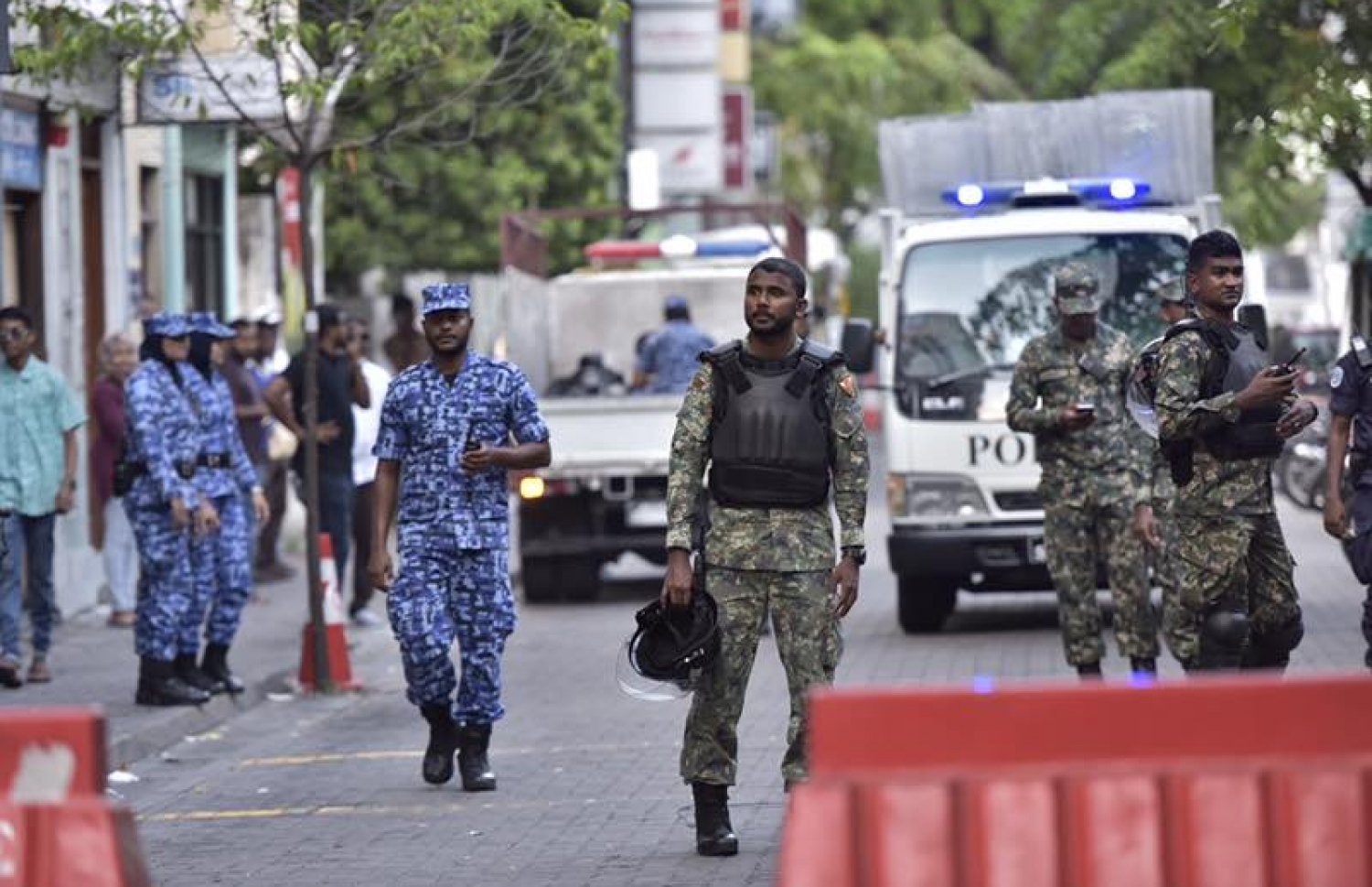 ޖުމްހޫރީ ޕާޓީގެ ލީޑަރު ގާސިމް އިބްރާހިމް ހައްޔަރުކޮށް، ބަންދުގެ މުއްދަތު އިތުރުކުރުމަށް ކޯޓަށް ހާޒިރުކުރުމާ ދިމާކޮށް މަގުމައްޗަށް އެއްވި މީހުން ފަހަތަށް ޖައްސަން ސަލާމަތީ ބާރުތަކުން މަސައްކަތްކުރަނީ. -- ފޮޓޯ: ނިޝާން އަލީ/މިހާރު