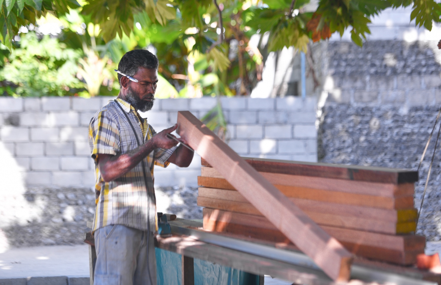 ރ.ފައިނު: ޖުލައި 7، 2017- ވަޑިއަކު، އޭނާގެ ގޭގެ ބޭރުގައި ހުރި ގަހެއްގެ ދަށުގައި ހަދާފައި ހުންނަ ވަޑާންކުރާ ތަނުގައި، ގެއެއްގެ ދޮރެއް ޖަހަނީ. --މިހާރު ފޮޓޯ: ހުސައިން ވަހީދު