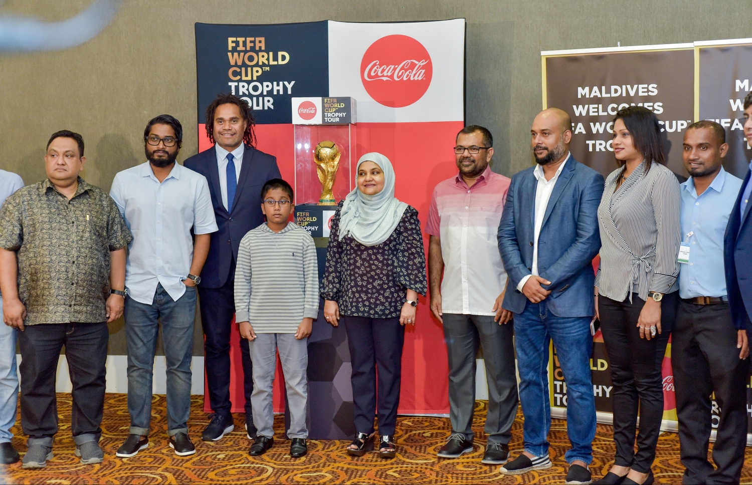 ވެލާނާ އިންޓަނޭޝަނަލް އެއާޕޯޓްގެ ވީއައިޕީ ލޯންޖުގައި ވޯލްޑް ކަޕް ތަށި ބަހައްޓާފައިފައިވާއިރު، ފަސްޓް ލޭޑީ ފާތިމަތު އިބްރާހީމާއި ޓޫރިޒަމް މިނިސްޓަރު ޒަމީރު އަދި އެފްއޭއެމްގެ ރައީސް ބައްސާމައި އެ އިދާރާގެ އިސް އޮފިޝަލުން އެ ތަށި ކައިރީގައި ފޮޓޯއެއް ނަންގަވަނީ.--- ފޮޓޯ: ނިޝާން އަލީ/ މިހާރު