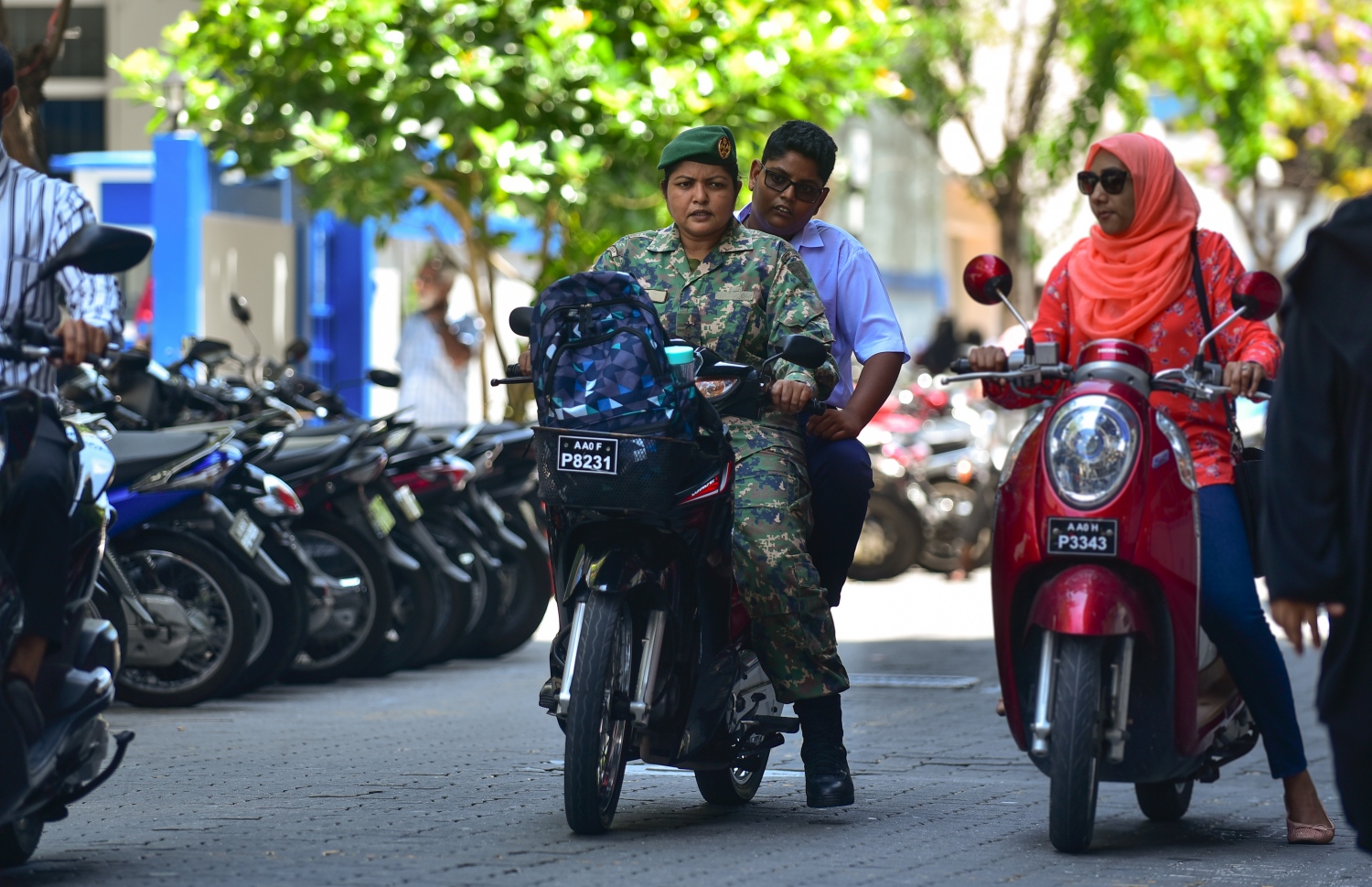 ބައިނަލްއަގްވާމީ އަންހެނުންގެ ދުވަސް: މާޗް 8، 2018- އަންހެން ސިފައިންގެ މީހަކު، ކުއްޖަކު ގޮވައިގެން ސައިކަލްގައި ސްކޫލަށް ދާއިރު އެހެން އަންހެނަކު ސައިކަލް މަތީގައި މަޑުކޮށްލައިގެން: ސިފައިންގެ އަށް އަންހެނުން ވައްދަން ފެށީ ނޮވެމްބަރު 3، 1988 ގައި ރާއްޖެ އަށް ކުރިމަތިވި އުދުވާނީ ހަމަލައަށް ފަހު. އޭގެ ފަހުން އަންހެން ސިފައިންގެ ބައިވެރިވުން ރާއްޖޭގެ އަސްކަރިއްޔާގައި އަންނަނީ އިތުރުވަމުން.---ފޮޓޯ: ހުސެއިން ވަހީދު/މިހާރު
