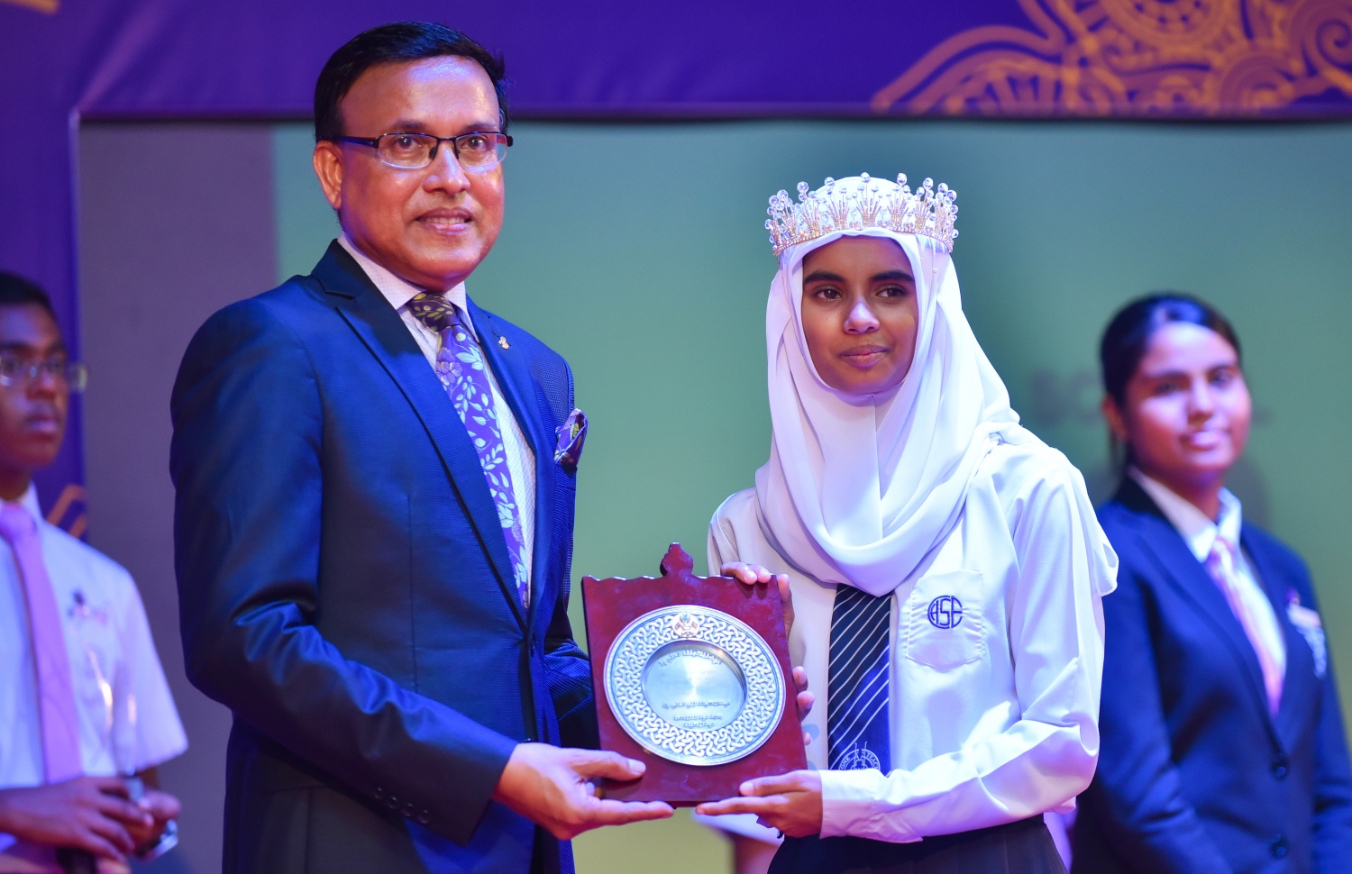 ހިރިޔާ ސްކޫލުގެ މިދިޔަ އަހަރުގެ އިނާމު ދިނުމުގެ ޖަލްސާގައި އެ ސްކޫލުން އެއް ވަނަ ހޯދި ދަރިވަރަށް، ޖަލްސާގެ ޝަރަފުވެރި މެހެމާނު އަދި އެޑިއުކޭޝަން މިނިސްޓްރީގެ ސްޓޭޓް މިނިސްޓަރު އަބްދުﷲ ނަޒީރު، ހަނދާނީ ފިލާ ހަވާލުކުރައްވަނީ.---ފޮޓޯ: ހުސައިން ވަހީދު/މިހާރު