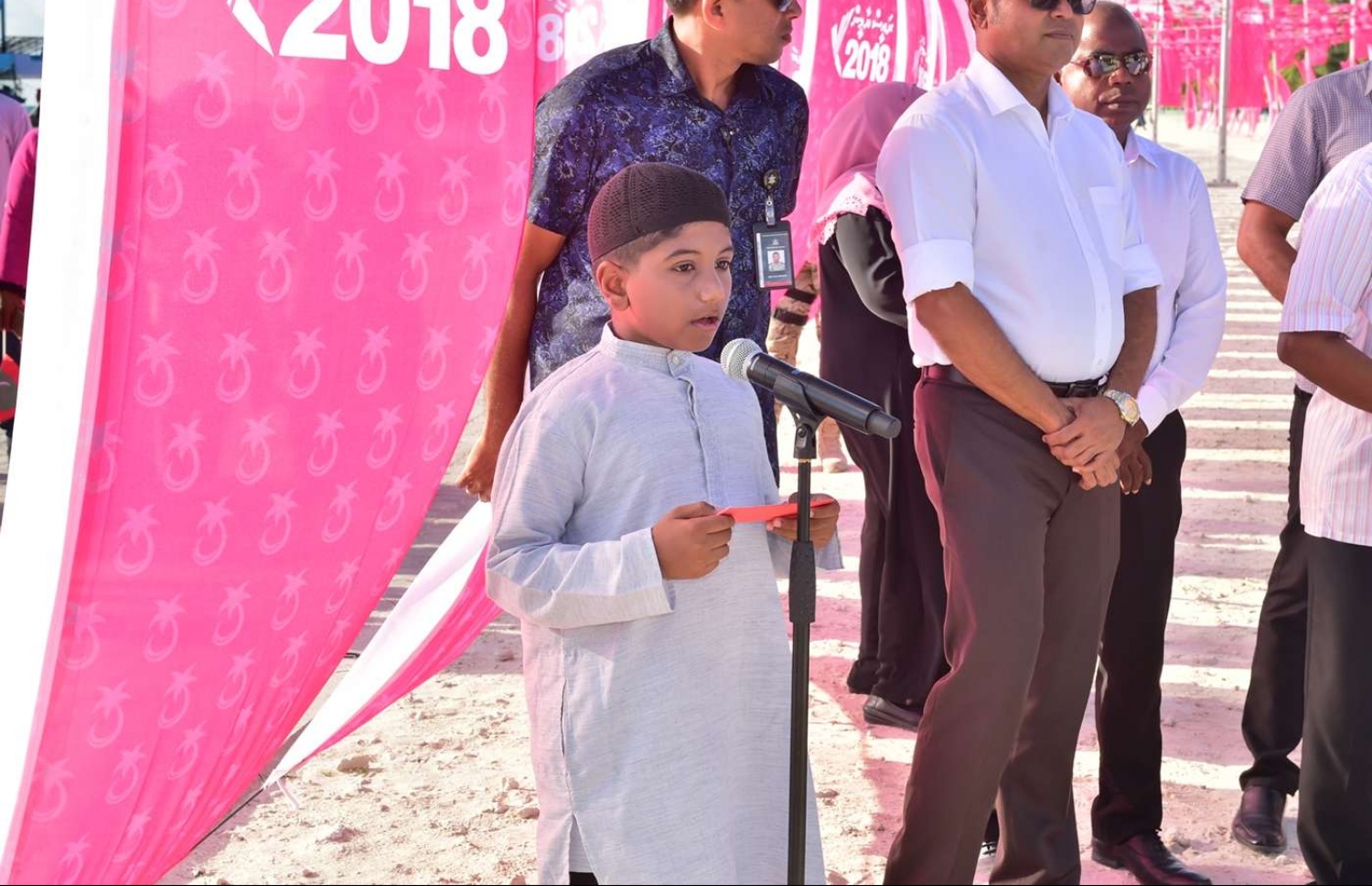 ސެޕްޓެމްބަރު 9، 2018- ރައީސް އަބްދުﷲ ޔާމީން ލ. އަތޮޅަށް ކުރެއްވި ކެމްޕެއިން ދަތުރުފުޅުގައި، ގަމު ތުނޑީ އަވަށު ބަނދަރު ހުޅުވުމުގެ ޖަލްސާގައި ކުޑަކުއްޖަކު ޤުރުއާން ކިޔަވަނީ.---ފޮޓޯ: ރައީސް އޮފީސް