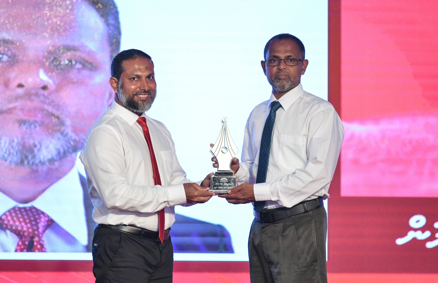 މާލެ: ޑިސެމްބަރު 11، 2018: ރާއްޖޭގެ ނޫސްވެރިކަމަށް 75 އަހަރު ފުރުމުގެ އަލިމަސްޔޫބީލް ފާހަގަ ކުރުމަށާއި ނޫސްވެރިކަމުގެ މިދިޔަ އަހަރުގެ އިނާމުތައް ދިނުމަށް މޯލްޑިވްސް މީޑިއާ ކައުންސިލާއި ހޯމް މިނިސްޓްރީ ގުޅިގެން ބޭއްވި ޖަލްސާގައި ނޫސްވެރިކަމުގެ ރަން ގަލަން ހާސިލްކުރެއްވި ބޭފުޅުންގެ ތެރެއިން "ހަވީރު" އަދި "މިހާރު"ގެ ސީނިއާ އެޑިޓަރުކަން ކުރެއްވި އަހުމަދު އަބްދުﷲ ސައީދުއަށް ހޯމް މިނިސްޓަރު ޝޭހް އިމްރާން އެވޯޑު ދެއްވަނީ.---ފޮޓޯ: އަހުމަދު ނިޝާތު/މިހާރު