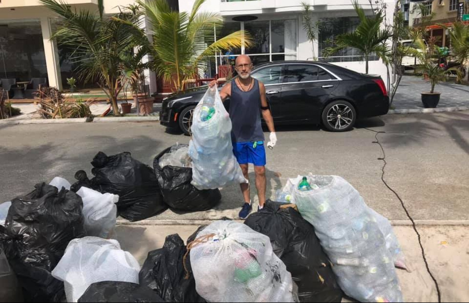 ހުޅުމާލޭގައި މީހަކު ކުނިތަކެއްގެ ކައިރީގައި ފޮޓޯއަކަށް ހުއްޓިގެން.