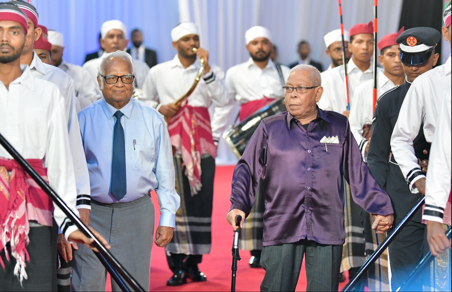 މާލެ: އޮކްޓޯބަރު 29، 2019: ދިވެހިރާއްޖޭގެ ގައުމީ ދުވަހުގެ ރަސްމިއްޔާތުގައި ނިޝާން އިއްޒުއްދީން އިއްޒަތުގެ ވެރިޔާގެ ލަގަބް ލިބިވަޑައިގެންނެވި ދިވެހި ބަހާއި ތާރީޚަށް ދިގު މުއްދަތެއްގައި ޚިދުމަތް ކުރެއްވި އަބްދުﷲ ސޯދިގު (ސޯދުބެ) އާއި ރާއްޖޭގެ ފުރަތަމަ އިންޖިނޭރު ހ.ހިކަރީ އަހުމަދު އާދަމް (ހިކަރީ) ލަގަބު ލިބިގެންނެވުމަށް، ރަސްމީ އިއްަތުގައި ސްޓޭޖަށް ވަޑައިގަންނަވަނީ.--- ފޮޓޯ: ހުސައިން ވަހީދު /މިހާރު