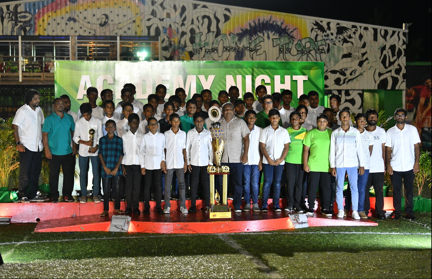 މާޒިޔާ އެކެޑަމީގެ 12 އަހަރުން ދަށާއި 14 އަހަރުން ދަށުގެ ޓީމާ އެކު އެ ޓީމުގެ ޗެއާމަން ސާޖިދު ފޮޓޯ އަކަށް ހުއްޓިގެން. -- ފޮޓޯ: ހުސެއިން ވަހީދު/ މިހާރު