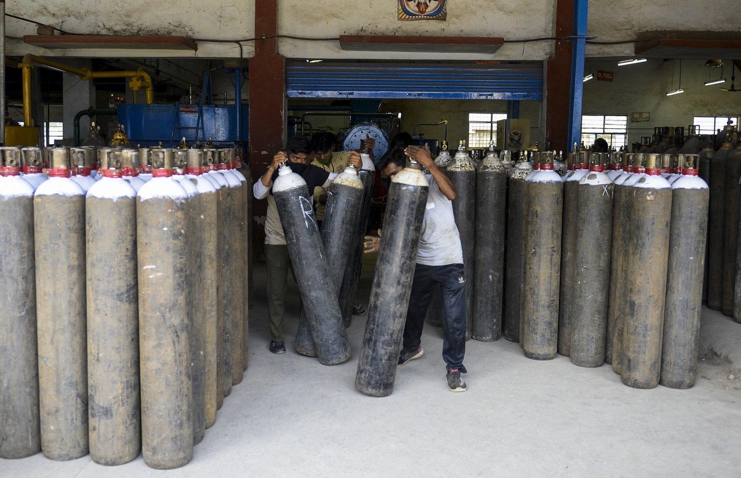 އިންޑީއާ: އޭޕްރިލް 24، 2021: ކޮވިޑް-19 އަށް ފަރުވާދެމުންދާ ބަލިމީހުންނަށް މެޑިކަލް އޮކްސަޖަން ސިލިންޑަރު ފޯރުކޮށްދިމުގައި ފްރަންޓްލައިންގައި މަސައްކަތް ކުރަމުންދާބަޔަކު އެހީތެރިވަނީ.-- ފޮޓޯ: އޭއެފްޕީ