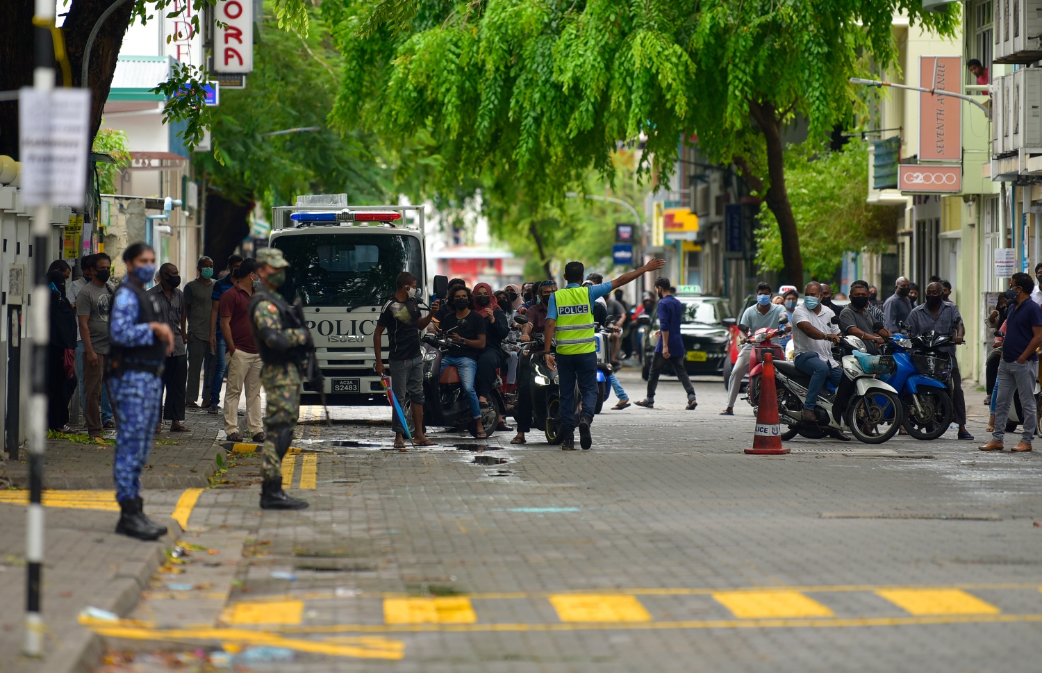 މާލެ- މެއި 13، 2021: ކުރީގެ ރައީސް މުހަންމަދު ނަޝީދު އަވަހާރަކޮށްލަން މިދިޔަ ބުރާސްފަތި ދުވަހުގެ ރޭ މާލޭގައި ގޮއްވާލި ބޮމުގެ ހަމަލާގައި ޒަހަމްވެ ވަޑައިގަތުމަށް ފަހު، އިތުރު ފަރުވާ އަށް އެމަނިކުފާނު ޖަރުމަނުވިލާތަށް މިއަދު ވަނީ ގެންގޮސްފައި: ފޮޓޯ އިން އެ ފެންނަނީ އޭޑީކޭ ސަރަހައްދުގައި ސިފައިންނާއި ފުލުހުން ފޯރިމަރާ މަންޒަރު -- ފޮޓޯ: އަހުމަދު އަވްޝަން/ މިހާރު