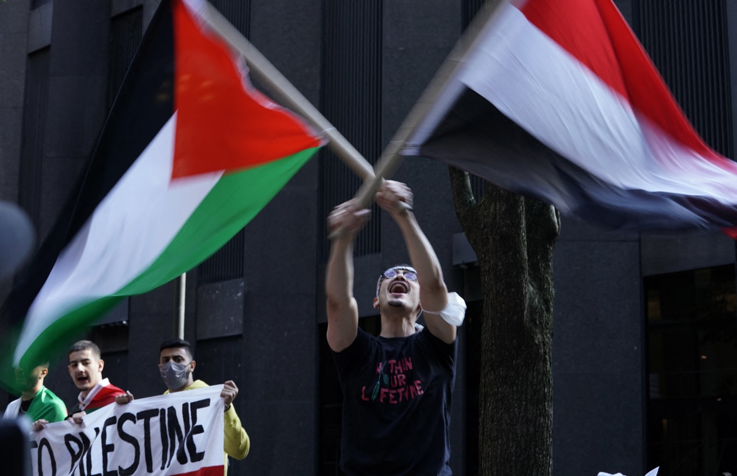 ނިއު ޔޯކު: މޭ 17، 2021: އިޒްރޭލުން ގާޒާއަށް ދެމުންދާ ބޮމުގެ ހަމަލާ އާއި ދެކޮޅަށް ކުރަމުންދާ މުޒާހަރާގައި ފަލަސްތީނާއެކު ވާކަން އެންގުމުގެ ގޮތުން ދުނިޔޭގެ އެކި ގައުމުތަކުގައި ބާއްވަމުންދާ މުޒާހަރާއެއްގައި ބަޔަކު އަޑުއުފުލަނީ.-- ފޮޓޯ: އޭއެފްޕީ