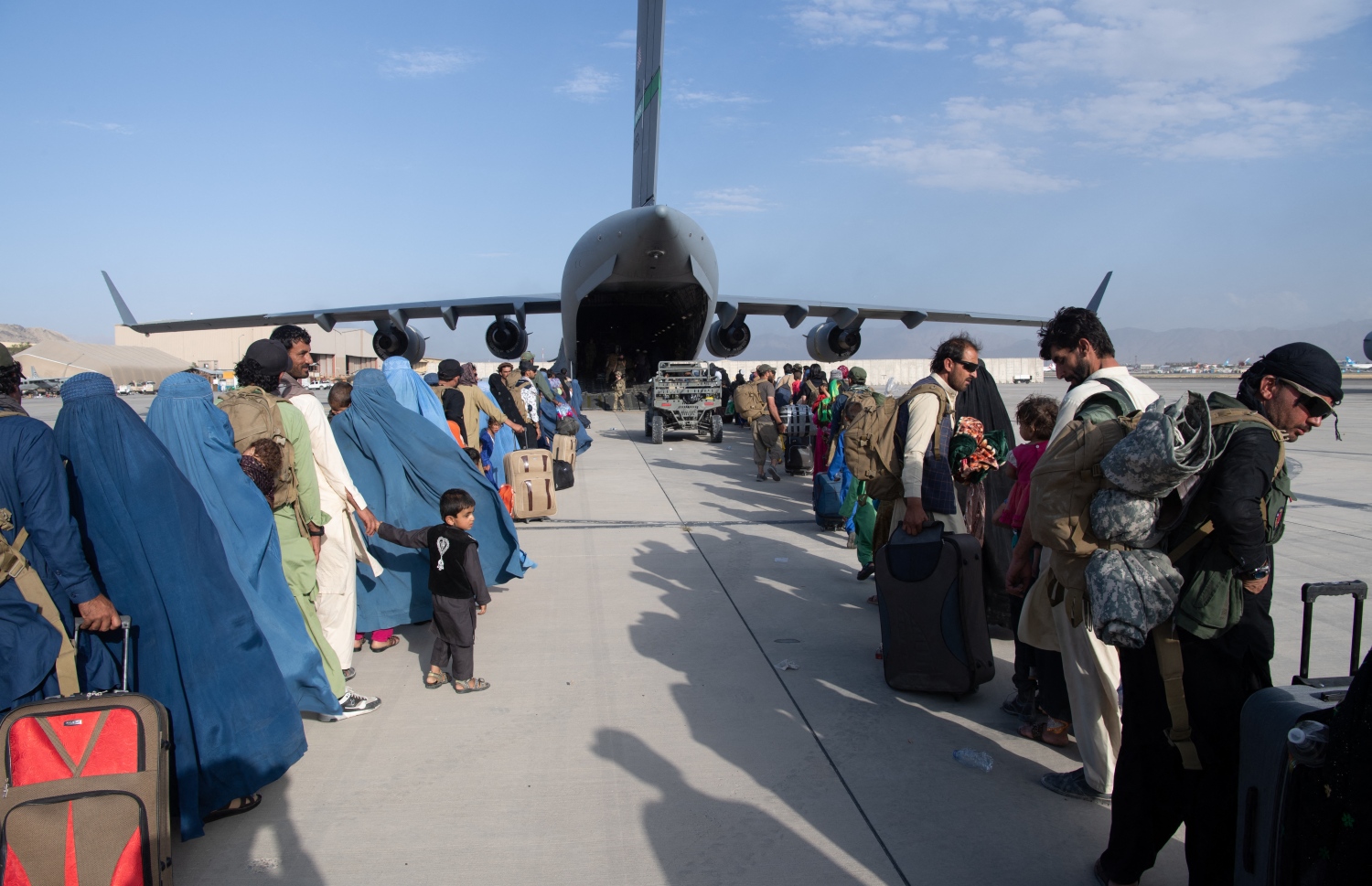 އަފްޣާނިސްތާނުން ބޭރުވުމަށް އެމެރިކާގެ އަސްކަރީ މަތިންދާ ބޯޓަކަށް އެރުމަށް ކާބުލްގެ އެއާޕޯޓުގައި ބަޔަކު ކިޔޫ ހަދާފައި. --ފޮޓޯ:އޭއެފްޕީ