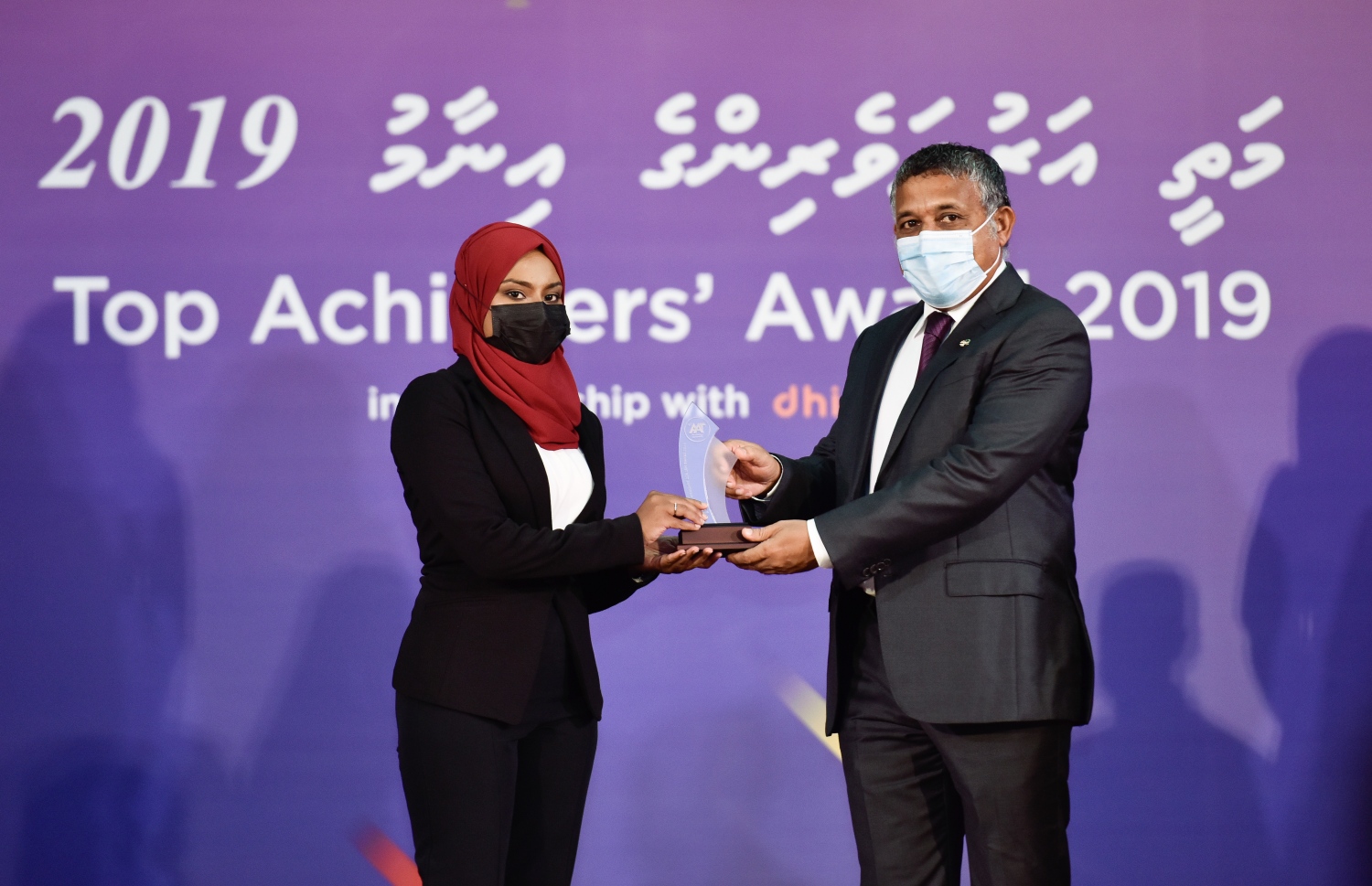 މާލެ: އޮކްޓޫބަރު 17، 2021- މެއި/ޖޫން، 2019ގެ މަތީ ސާނަވީ އިމްތިހާނުން އެންމެ މޮޅު ދަރިވަރުންނަށް އިނާމު ދިނުމަށް ތާޖުއްދީން ސުކޫލުގައި ބޭއްވި ރަސްމިއްޔާތުގައި އެވޯޑު ހާސިލް ކުރި ދަރިވަރުންނާއި ހައުސިން މިނިސްޓަރު އަހުމަދު އަސްލަމް އެވޯޑު ހަވާލުކުރައްވަނީ.--- ފޮޓޯ: ފަޔާޒު މޫސާ / މިހާރު