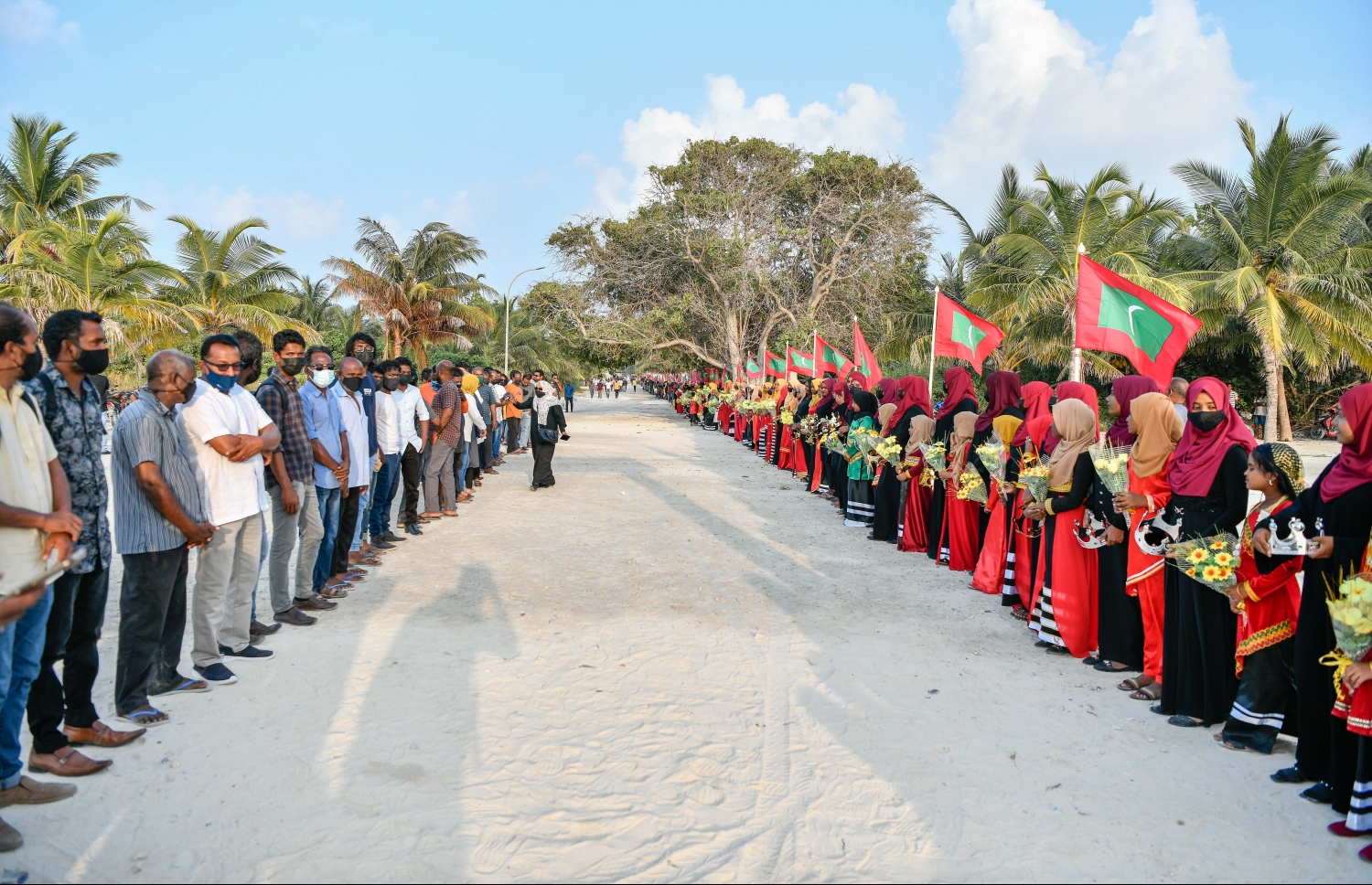 ފައްޔާޒަށް މަރުހަބާ ކިޔަން އެމްޑީޕީގެ މެމްބަރުން މިލަންދޫގެ ބޮޑުމަގުގެ ދެ ފަރާތުގައި ސަފު ހަދާލައިގެން.---ފޮޓޯ: ނިޝާން އަލީ/ މިހާރު