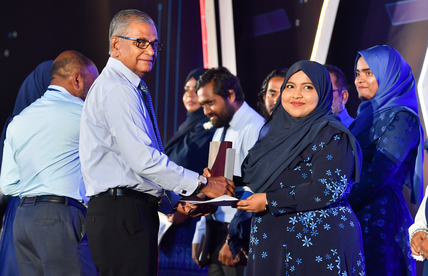 ސްޓެލްކޯގެ 25 ވަނަ އަހަރީ ދުވަސް ފާހަގަ ކުރުމަށް ދަރުބާރުގޭގައި ބޭއްވި ޖަލްސާގައި އެ ކުންފުނީގެ ކުރީގެ އެމްޑީ އަބްދުލް ޝުކޫރު، މުވައްޒަފަކަށް ހަދާނީ ފިލާ ހަވާލުކޮށްދެއްވަނީ--. ފޮޓޯ: ރައީސް އޮފީސް