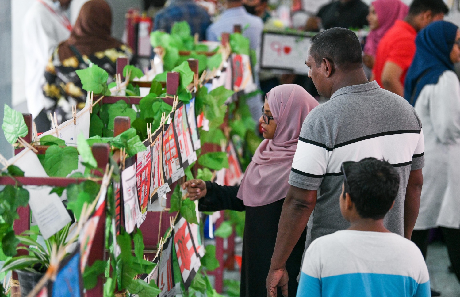 މަޖީދިއްޔާ ސްކޫލް ހޯލުގައި ކުރިއަށް ގެންދިޔަ "މައި މަޖީދިއްޔާ-ތްރޫ ދި މައިންޑްސް އެންޑް ހޭންޑް އޮފް މަޖީދިއަންސް" ގެ ނަމުގައި ބޭއްވި މައުރަޒުގައި ހުރި ކުރެހުންތައް އެ ސްކޫލްގެ ކުއްޖަކު ބެލެނިވެރިއަކާއެކު ބަލަނީ. -- ފޮޓޯ: ފަޔާޒު މޫސާ | މިހާރު