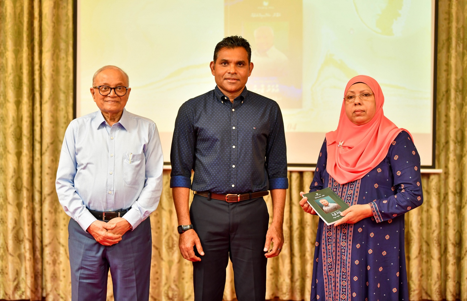 އުމަރު ޒާހިރާ ގުޅޭ ގޮތުން ކުރީގެ ރައީސް މައުމޫން އަބްދުލްގައްޔޫމުގެ ފައުންޑޭޝަނުން އިސްވެ ތައްޔާރުކުރި ފޮތެއް ނެރުމަށް ބޭއްވި ޖަލްސާގައި، ނައިބް ރައީސް ފައިސަލް ނަސީމް ފޮތް ނެރެދެއްވުމަށްފަހު، އުމަރު ޒާހިރުގެ ދަރިކަނބަލުން ސާމިޔާ އަދި މައުމޫން އަބްދުލް ގައްޔޫމް އާއެކު.---ފޮޓޯ: ރައީސް އޮފީސް