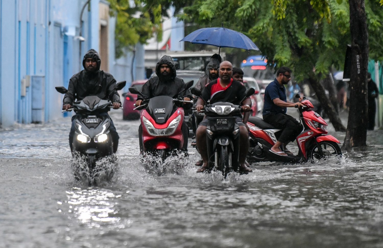 މީގެ ކުރިން މާލެއަށް ވިއްސާރަ ކުރި ދުވަހެއްގައި މަގުމަތީގައި ފެންބޮޑުވެފައި އޮއްވައި ބަޔަކު ވެހިކަލް ދުއްވާފައި އަންނަނީ.-- ފޮޓޯ: ފަޔާޒް މޫސާ | މިހާރު