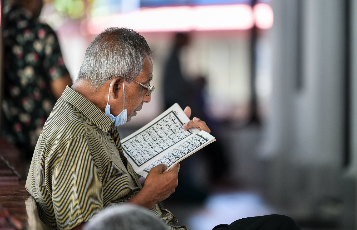 އިސްލާމީ މަރުކަޒުގައި ޖަމާއަތުގައި ކުރި މެންދުރު ނަމާދަށް ފަހު، މީހަކު ގުރުއާން ކިޔަވަނީ.---ފޮޓޯ: ފަޔާޒް މޫސާ/މިހާރު