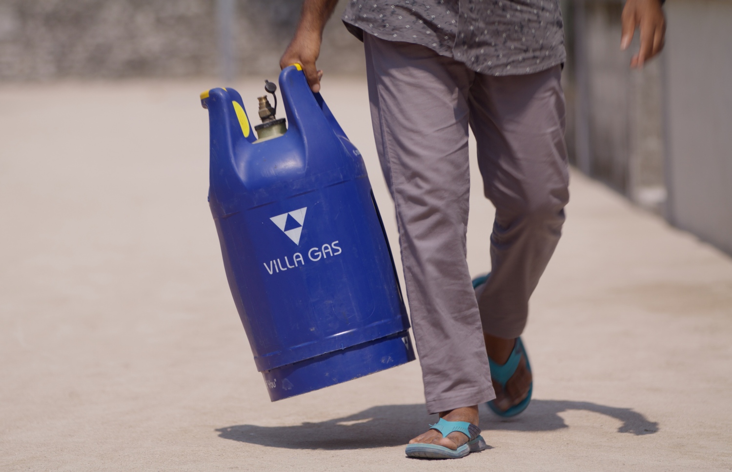 ހއ. މުރައިދޫގައި ވިލާ ގޭހުގެ ރީޓެއިލް ވިޔަފާރިކުރާ މުހައްމަދު ހާލިދު ގޭސްފުޅިއެއް ހިފައިގެން ދަނީ.-- ފޮޓޯ: ވިލާ