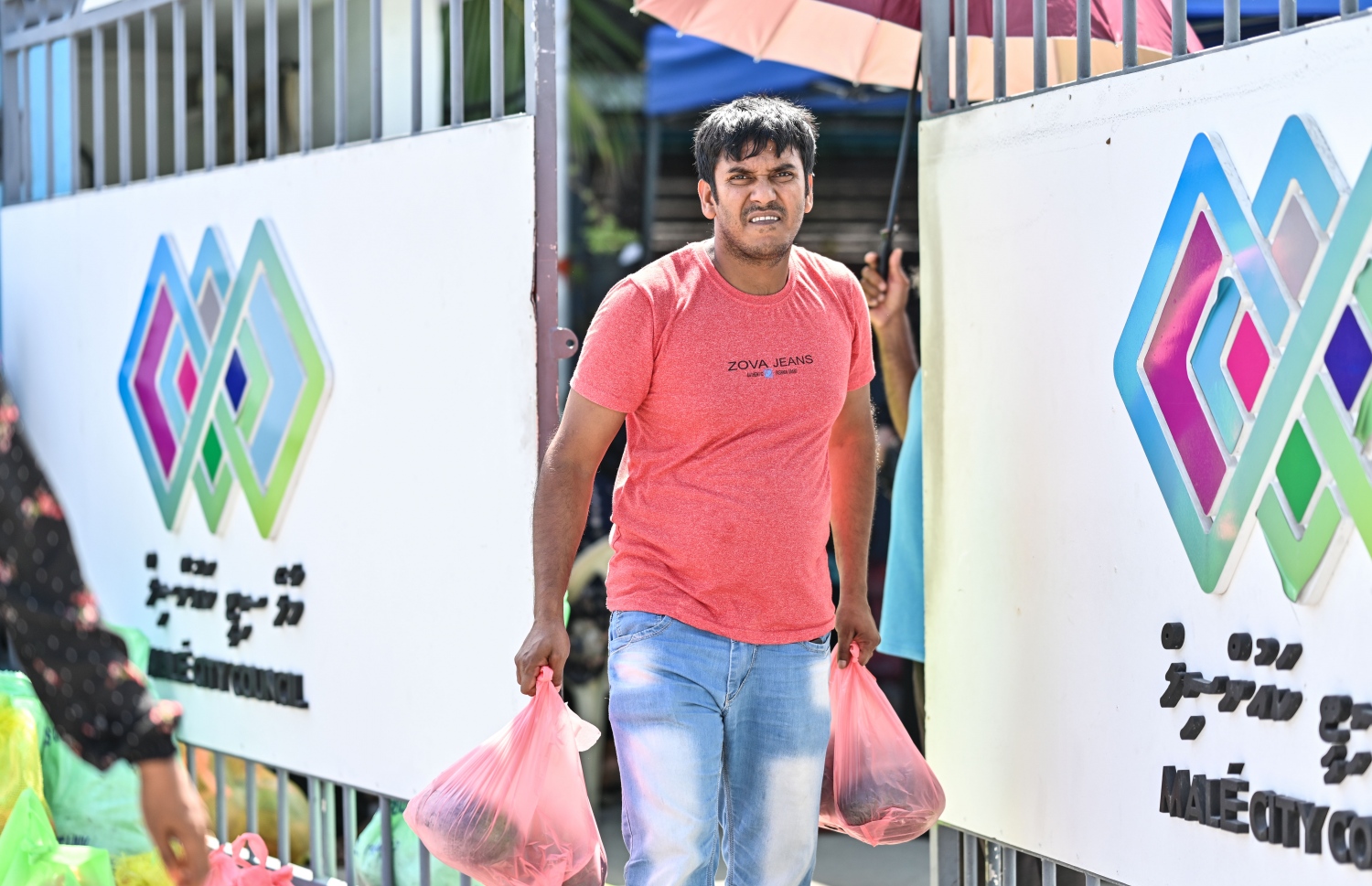 ދިވެހިންނަށް ބެހުމަށް ޗަމްޕާ ބްރަދާސްގެ ފަރާތުން ހަދިޔާކުރި ކަރަ އާއި ކާށި ލިބުނު މީހަކު، ސިޓީ ކައުންސިލްގެ އާންމު ހިދުމަތްތަކާ ބެހޭ އިމާރާތުން ނުކުންނަނީ.--- ފޮޓޯ: ނިޝާން އަލީ / މިހާރު