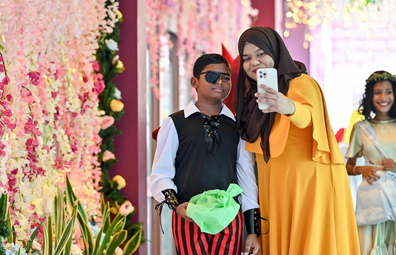 ކުޑަކުދިންގެ ދުވަސް ފާހަގަކުރުމަށް އިއްޒުއްދީން ސްކޫލުގައި މިއަދު ބޭއްވި ހާއްސަ ރަސްމިއްޔާތަގައި ޓީޗަރަކު ދަރިވަރަކާއެކު ސެލްފީއެއް ނަގަނީ: މިއަދުގެ ރަސްމިއްޔާތައް ސްކޫލް ތެރެ ވަރަށް ބޮޑަށް ޒީނަތްތެރިކޮށް، ޓީޗަރުންނާއި ދަރިވަރުން ސްކޫލަށް ދިޔައީ އެކި ކަހަލުގެ ކާޓޫން ކެރެކްޓާތަކުގެ ހެދުމުގައި.-- ފޮޓޯ: ނިޝާން އަލީ / މިހާރު