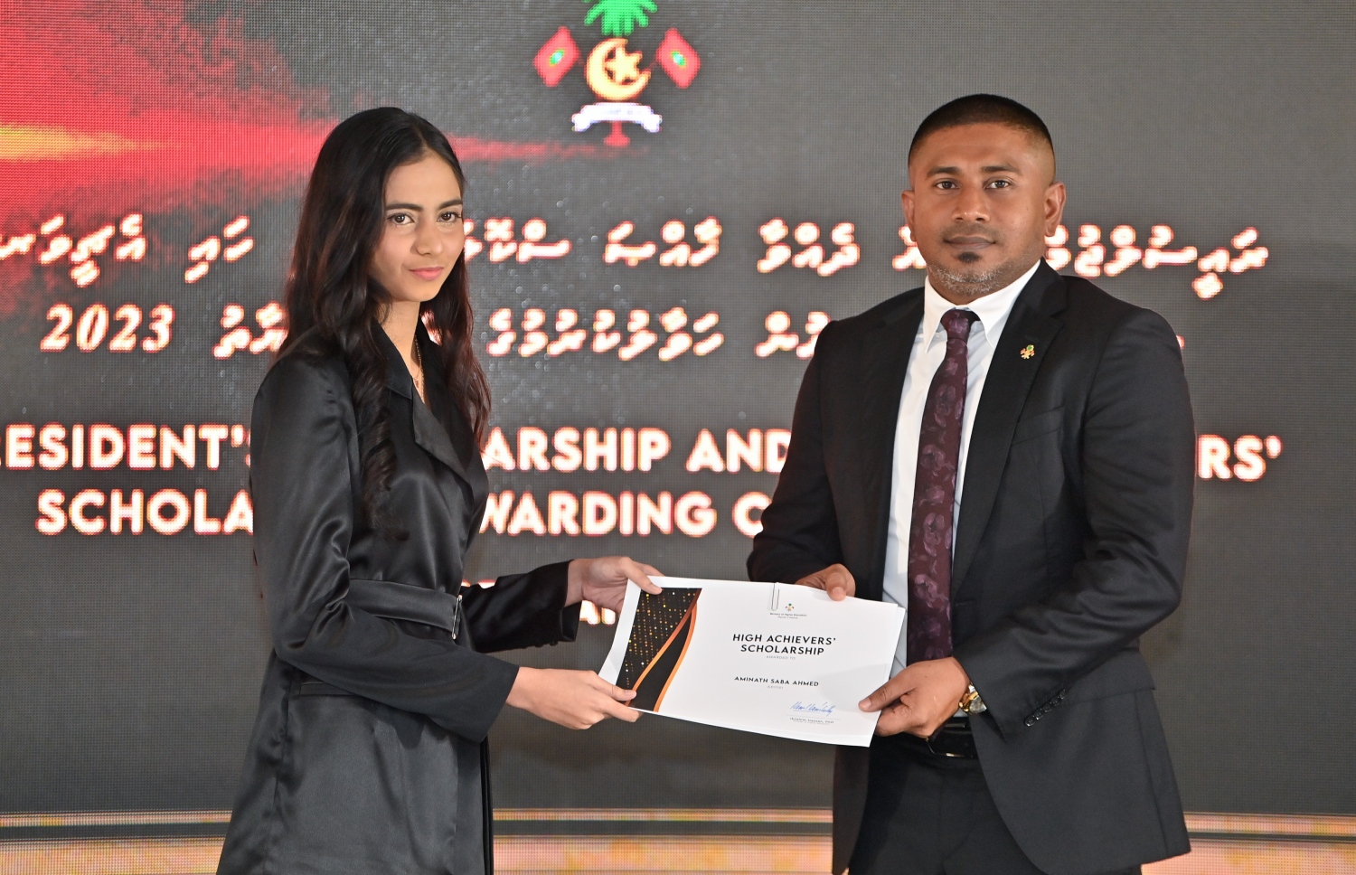 ރައީސްގެ އެވޯޑާއި ސްކޮލަޝިޕް ލިބުނު މަތީ ސާނަވީގެ ދަރިވަރުންނަށް ހަނދާނީ ލިޔުން ހަވާލުކުރުމަށް ބޭއްވި ރަސްމިއްޔާތުގައި ސްކޮލަޝިޕް ލިބުނު ދަރިވަރަކަށް ލިޔުން ހަވާލު ކުރައްވަނީ.-- ފޮޓޯ.-- ރައީސް އޮފީސް