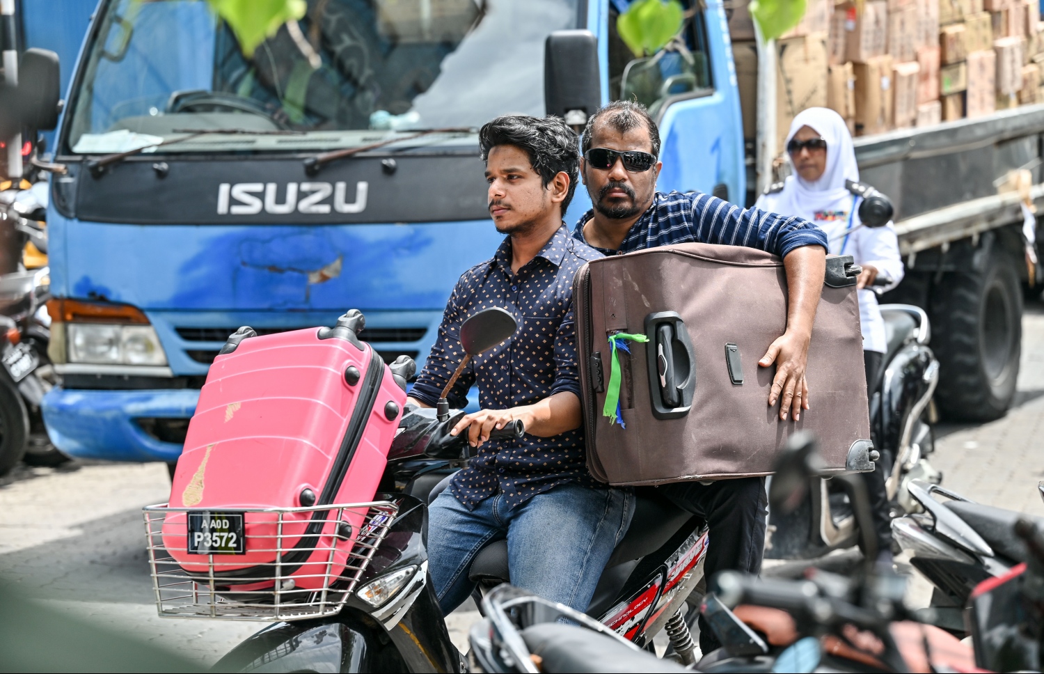 ބޮޑު ޗުއްޓީ އާއި އީދަށް ފުރާ ބަޔަކު އެމްއެމްއޭ ކުރިމަތިން ސައިކަލެއްގައި ލަގެޖު ހިފައިގެން ދަނީ: ބަންދަށް ގިނަ ބަޔަކު އަންނަނީ ރަށްރަށަށް ފުރަމުން.-- ފޮޓޯ: ނިޝާން އަލީ | މިހާރު