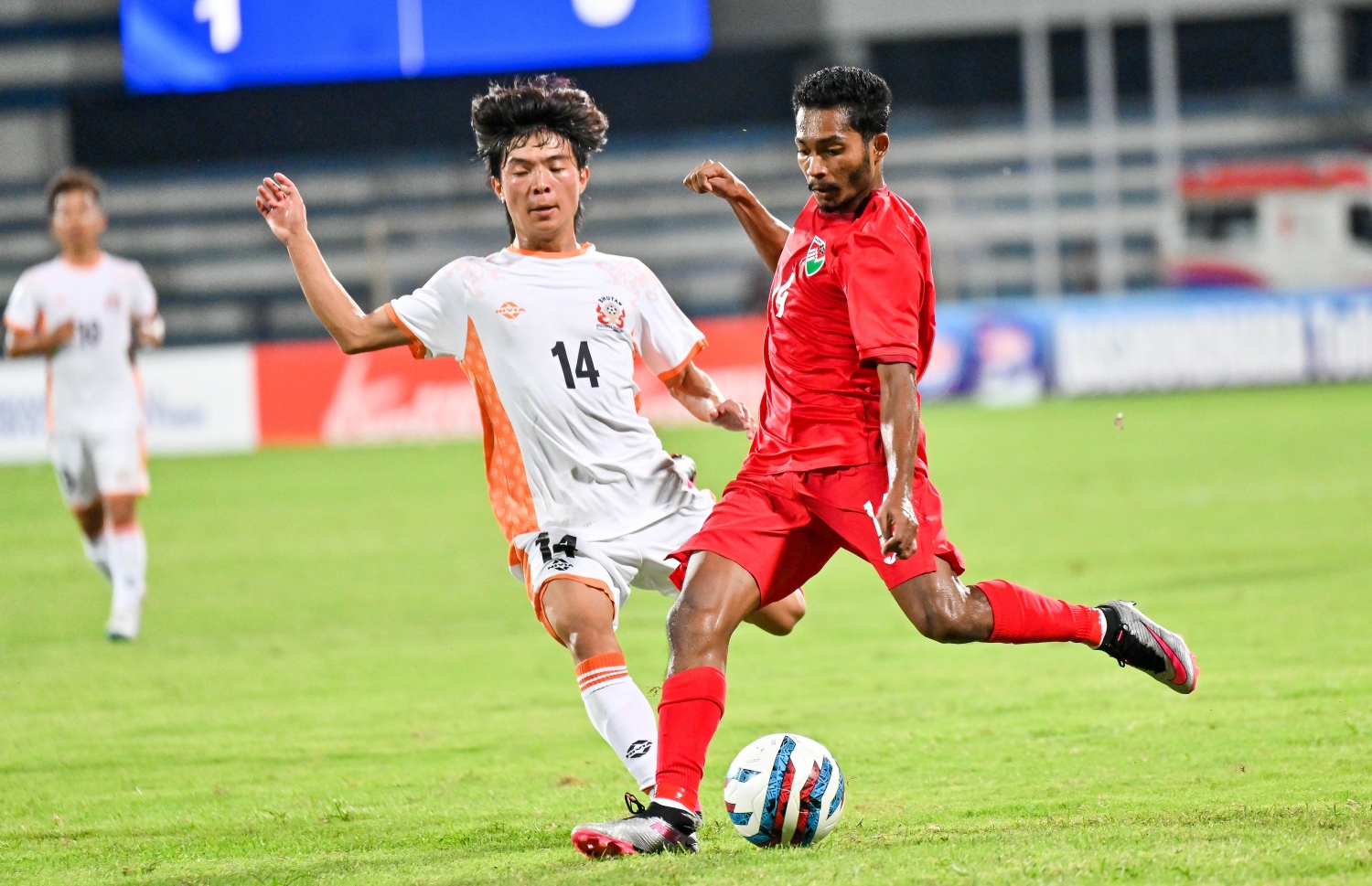 ސާފް ޗެމްޕިއަންޝިޕްގައި އިންޑިއާގެ ބެންގަލޫރުގެ ސްރީ ކަންތީވާ ސްޓޭޑިއަމްގައި ޖޫން 22، 2023 ގައި ބޫޓާނާ ދެކޮޅަށް ކުޅެ ރާއްޖެ 2-0 އިން މޮލުވި މެޗުގައި ރާއްޖޭގެ ހަސަން ހައިޝަމް ބޫޓާން ކުޅުންތެރިއެއްގެ ކައިރިން ނައްޓާލާފައި ބޯޅަ ހިފައިގެންދަނީ. -- ފޮޓޯ: ފަޔާޒު މޫސާ | މިހާރު