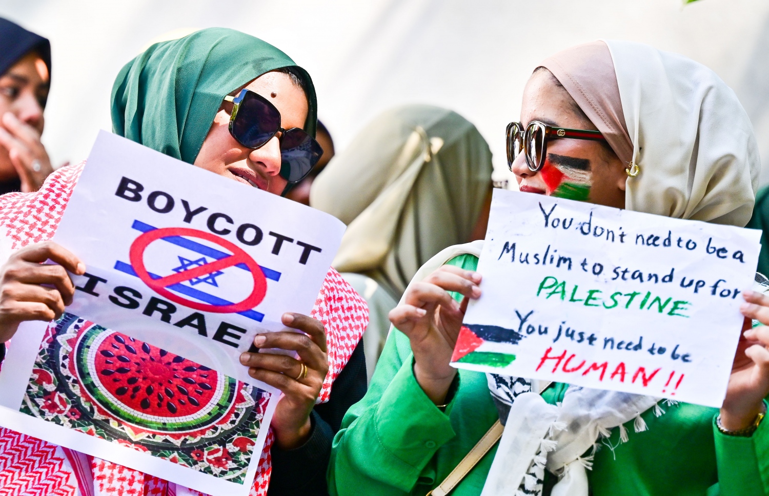 އިޒްރޭލުން ފަލަސްތީނުގެ މީހުންނާ ދެކޮޅަށް ހިންގާ ލާއިންސާނީ އަމަލުތައް ކުށްވެރިކޮށް، އެ ގައުމުގެ ޕާސްޕޯޓްގައި ރާއްޖެ އަށް ނާދެވޭ ގޮތް ހެދުމަށް ގޮވާލައި ޕްރެޝަރު ކުރުމަށް މިއަދު ރައްޔިތުންގެ މަޖިލީހުގެ އިދާރާ ކުރިމަތީ ބޭއްވި އިހުތިޖާޖުގެ ބައެއް ބައިވެރިން.--- ފޮޓޯ: ފަޔާޒު މޫސާ / މިހާރު