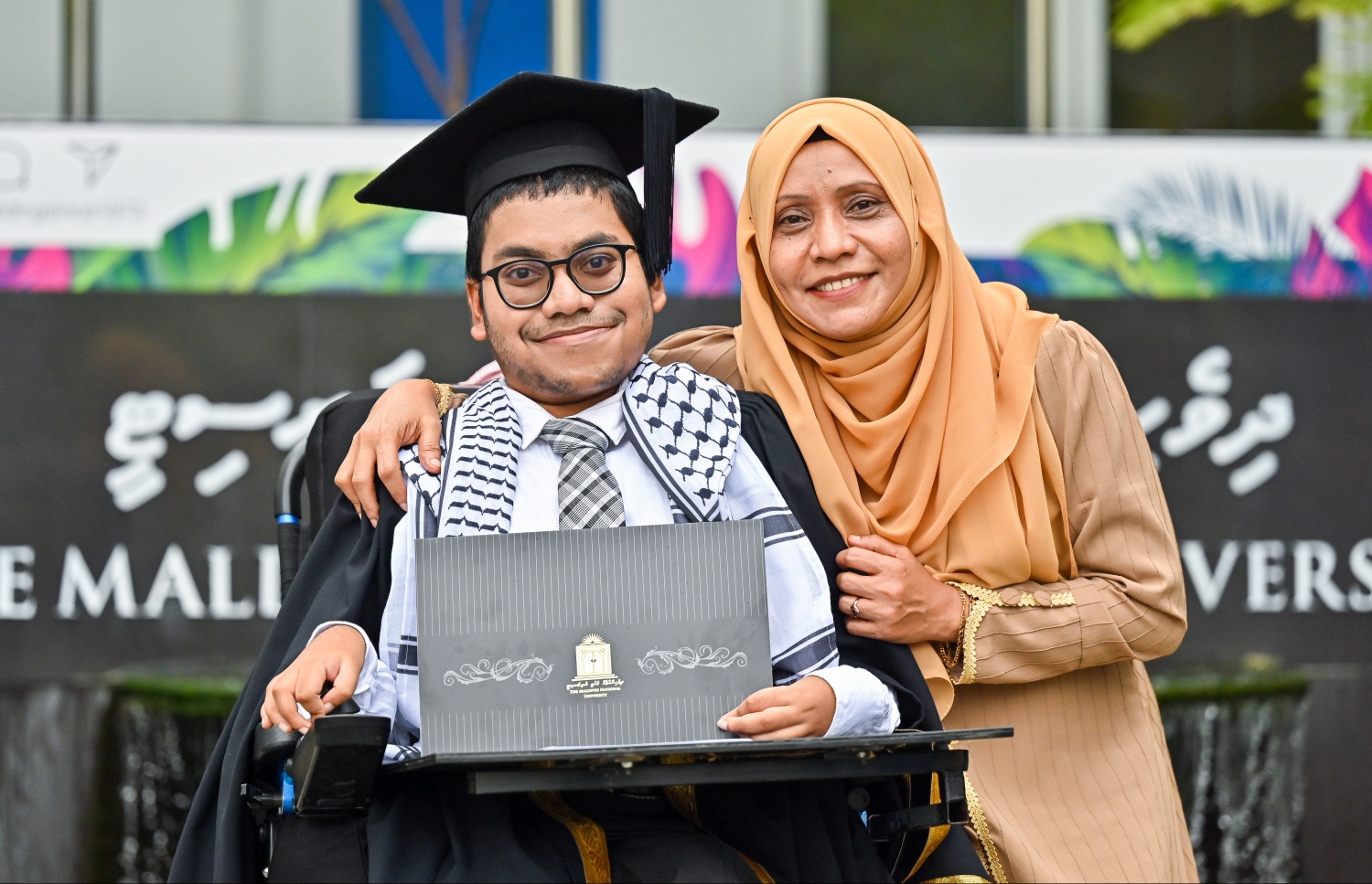 ރައިޝާން، ދަސްވެނިވުމުގެ ރަސްމިއްޔާތުގައި އޭނާގެ މަންމަ އައިންތުއާއެކު ފޮޓޯއަކަށް ހުއްޓިލައިގެން.-- ފޮޓޯ: ފަޔާޒު މޫސާ/ މިހާރު