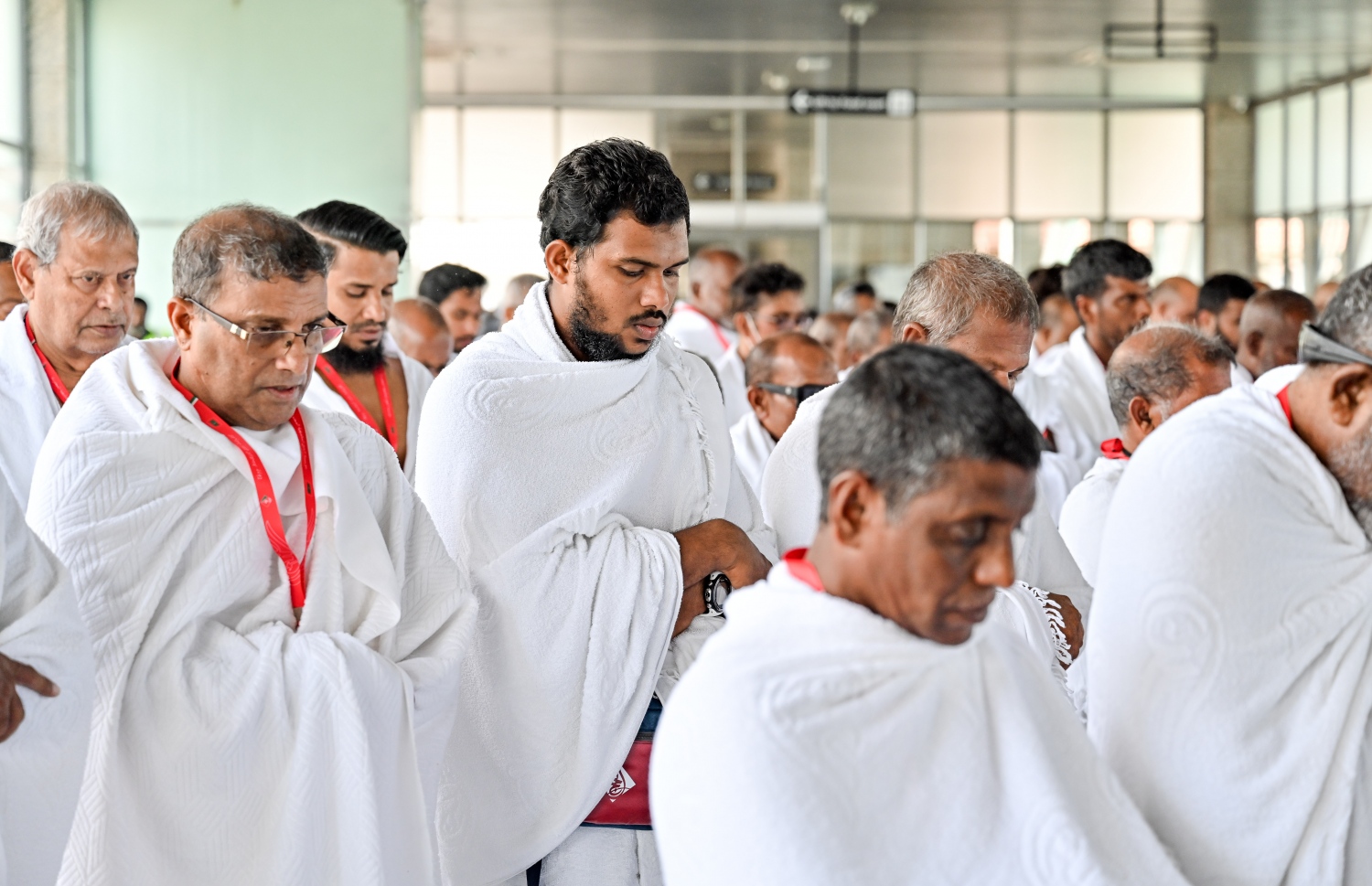 ރާއްޖެ އިން މި އަހަރު ހައްޖަށް ދާ މީހުންގެ ފުރަތަމަ ގުރޫޕްގެ މީހުން މިއަދު ފުރުމުގެ ކުރިން ވެލާނާ އިންޓަނޭޝަނަލް އެއާޕޯޓުގައި ހުކުރު ނަމާދު ކުރަނީ.--- ފޮޓޯ: ނިޝާން އަލީ | މިހާރު