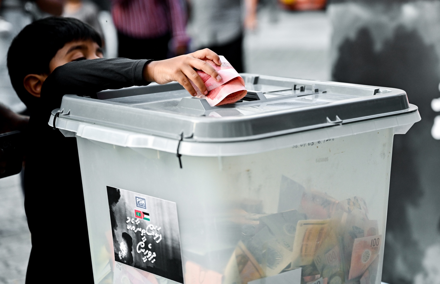 "ފަލަސްތީނާ އެކު ދިވެހީން" ނަމުގައި ދައުލަތުގެ މީޑިއާ ޕީއެސްއެމުން އިންތިޒާމު ކޮށްގެން މިއަދު ކުރިއަށް ގެންދާ ޓެލެތޯންގައި ހުޅުވާފައިވާ ފަންޑު ފޮއްޓަކަށް ކުޑަކުއްޖަކު ރުފިޔާ ލަނީ.-- ފޮޓޯ: ނިޝާން އަލީ | މިހާރު