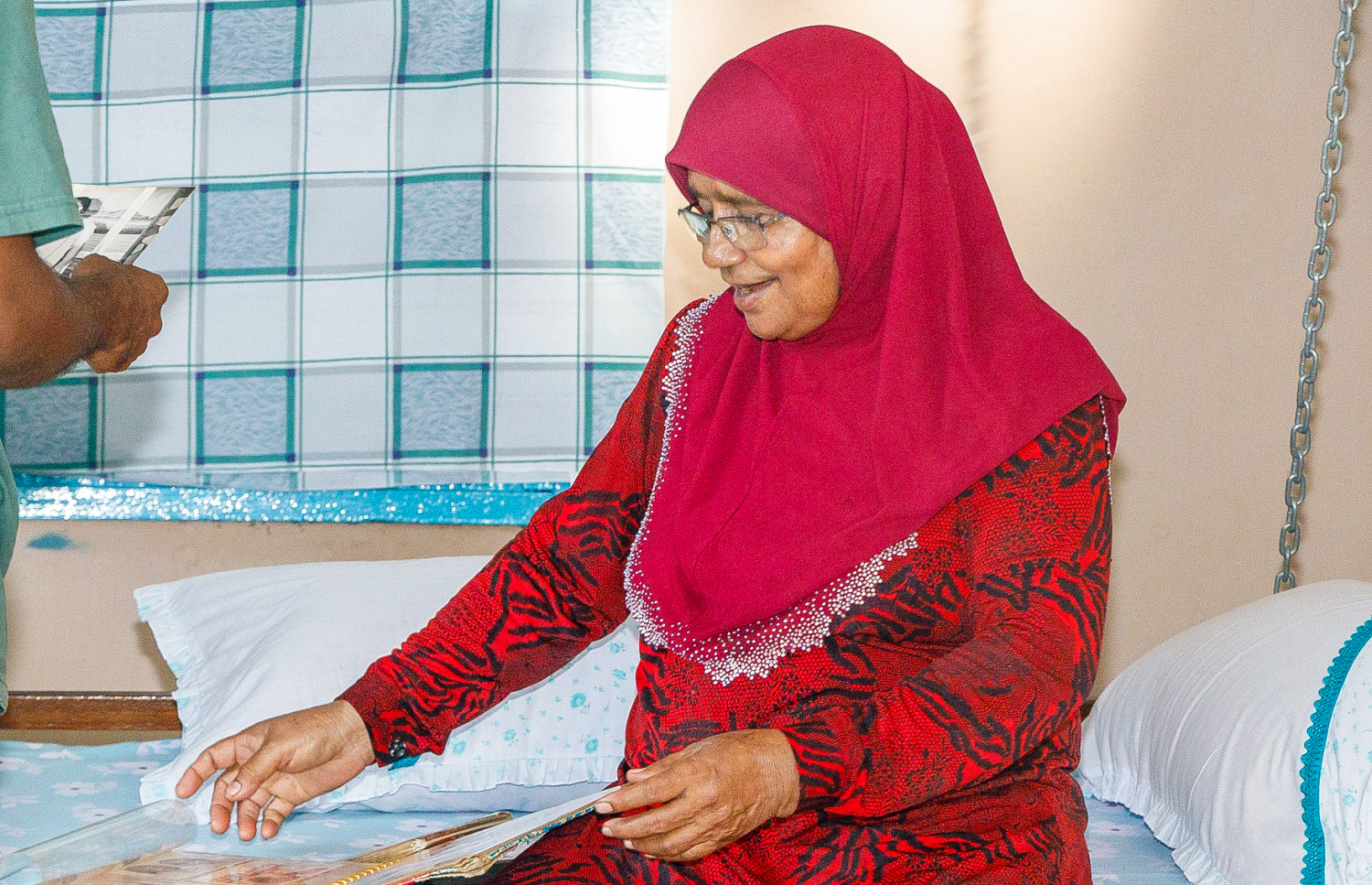 ވަހީދާ އޭނާގެ ގޭގެ ބޭރު އުނދޯލީގައި އިނދެ ފޮޓޯ އަލްބަމްތަކުން ފޯރީގައި ކުރީގެ ހަނދާންތައް ކިޔައި ދެނީ. -- މިހާރު ފޮޓޯ: އަލީ ނަސީރު