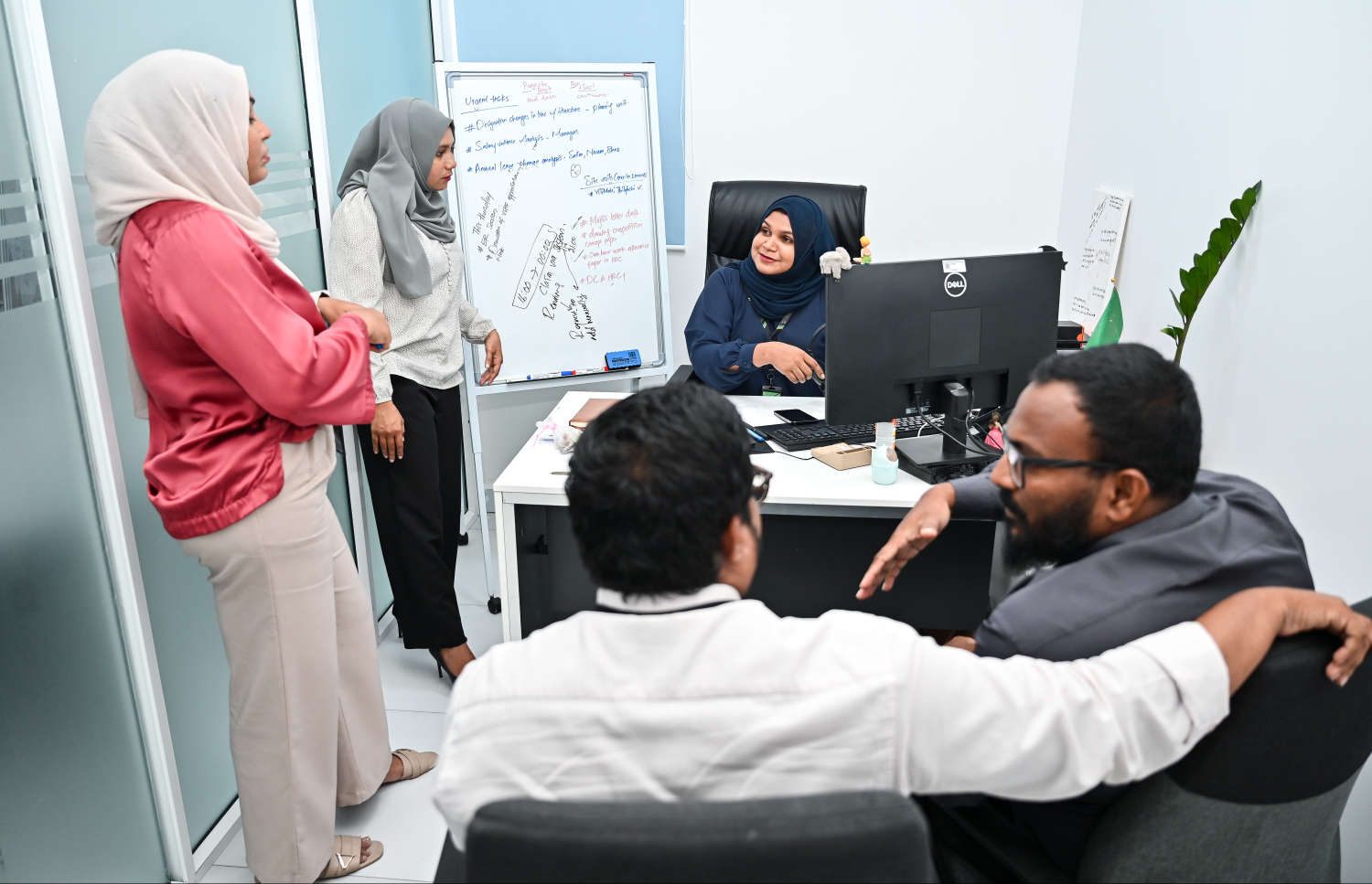 އައްޒަ އޭނާގެ ބައެއް މުވައްޒަފުންނާ އެކު އޮފީހުގައި. -- ފޮޓޯ: ފަޔާޒު މޫސާ | މިހާރު