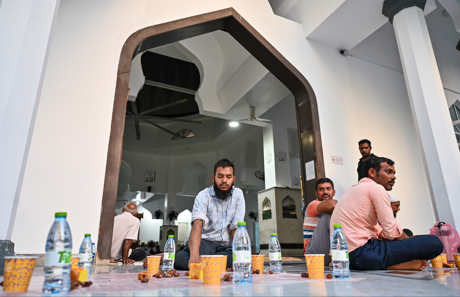 ބިދޭސީން ރޯދަވީއްލަން ކާއެއްޗެހި ނަގައިގެން، މަޣުރިބު ނަމާދަށް ބަންގި ގޮވާނެ ވަގުތެއްގެ އިންތިޒާރުގައި--- ފޮޓޯ: ފަޔާޒު މޫސާ | މިހާރު