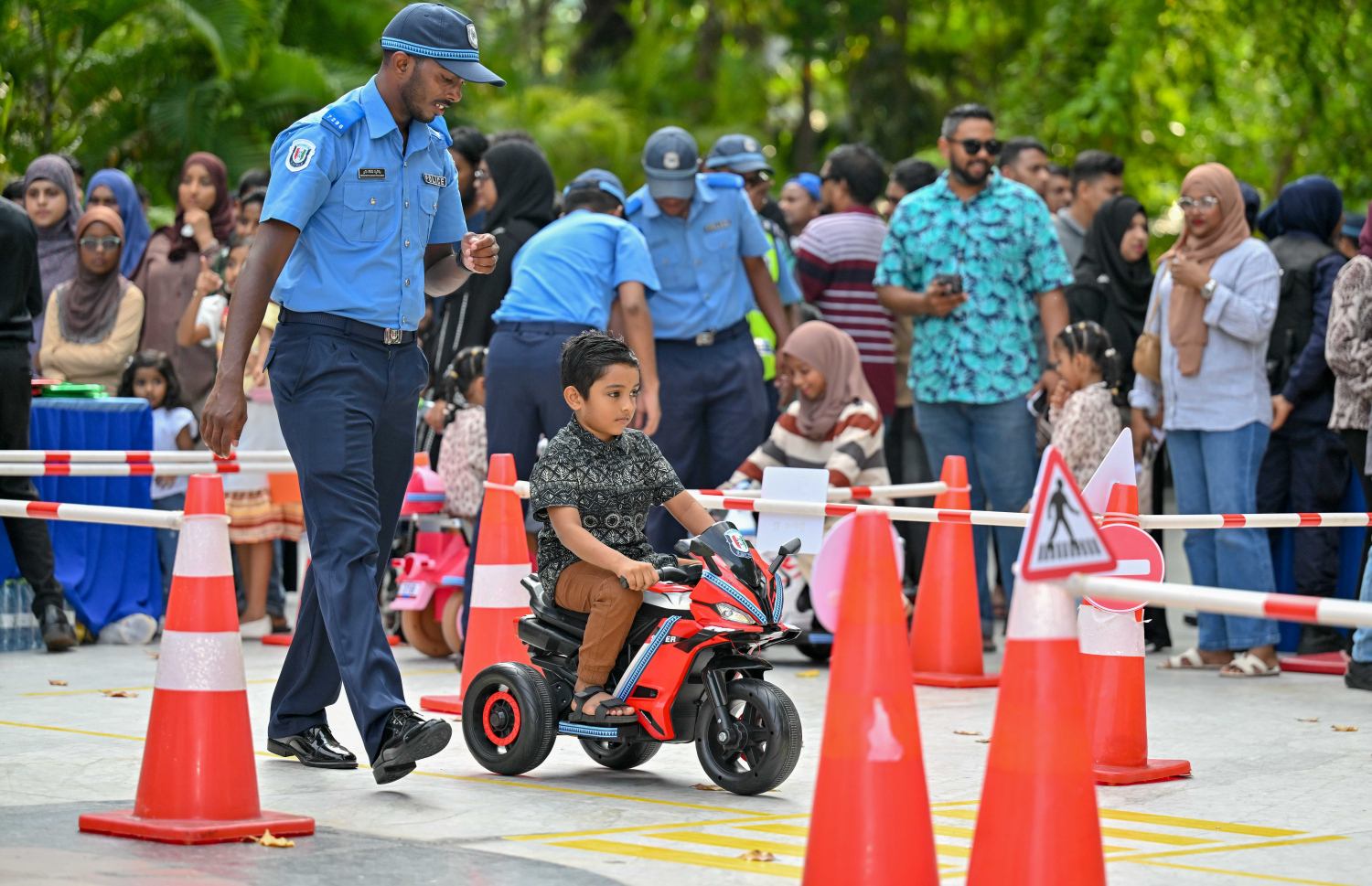 އީދު ދުވަހުގެ މުނާސަބަތުގައި ބޭއްވި އީދު ހަވީރުގައި ފުލުހުން ކުރިއަށް ގެންދިޔަ ހަރަކާތުގައި ކުއްޖަކު ބެޓެރީ ސައިކަލެއް ދުއްވަނީ -- ފޮޓޯ: ރައީސް އޮފީސް