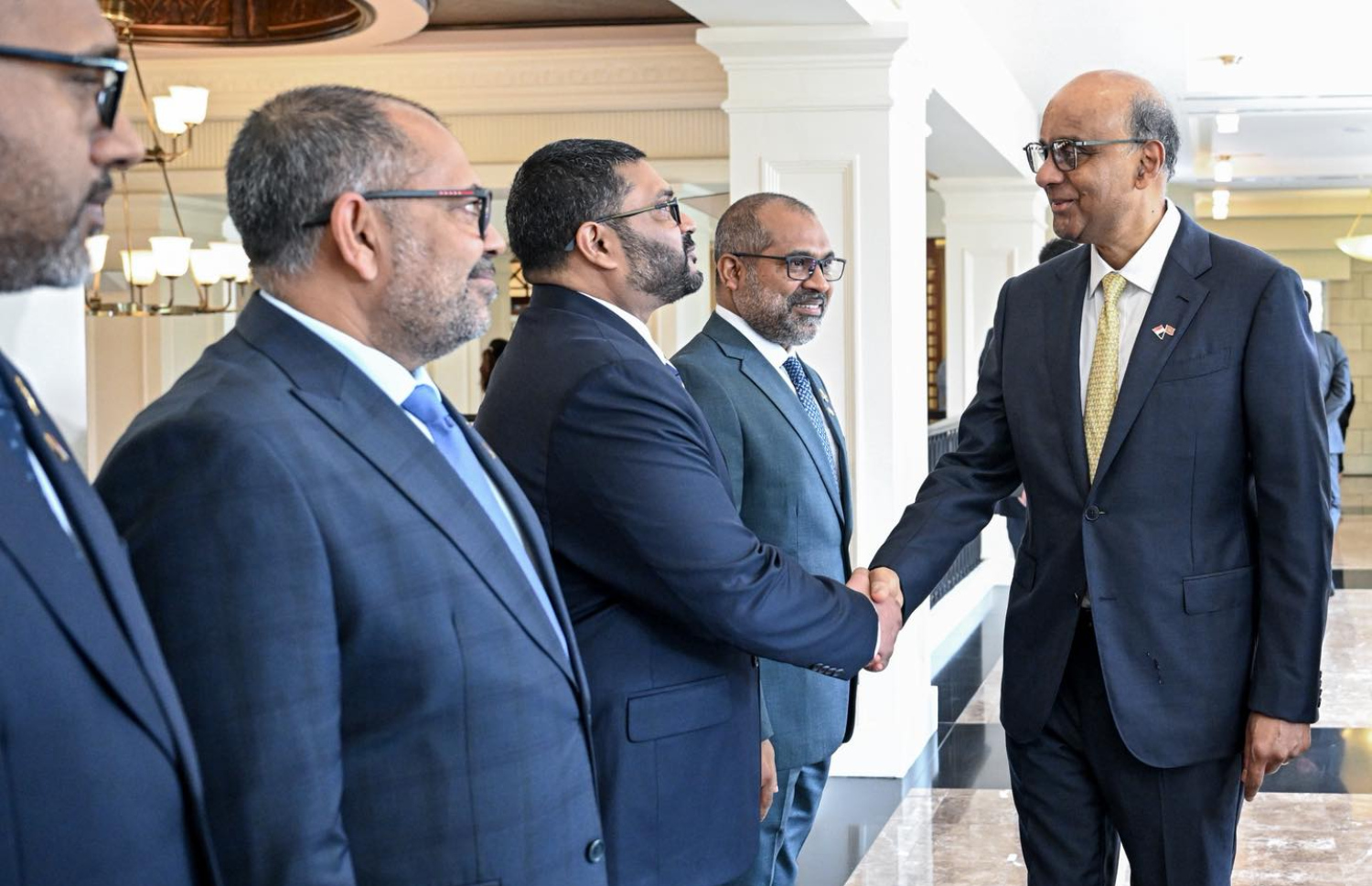 ރައީސް މުއިއްޒަށް ސިންގަޕޫރުން ރަސްމީކޮށް މަރުހަބާ ދަންނަވަން މިއަދު ބޭއްވި ރަސްމިއްޔާތުގެ ތެރެއިން، އެ ގައުމުގެ ރައީސް ތަރްމަން ޝަންމުގަރަނަމް ދިވެހި ވަފުދުގެ ބޭފުޅުންނާ ސަލާން ކުރައްވަނީ.---ފޮޓޯ: ރައީސް އޮފީސް