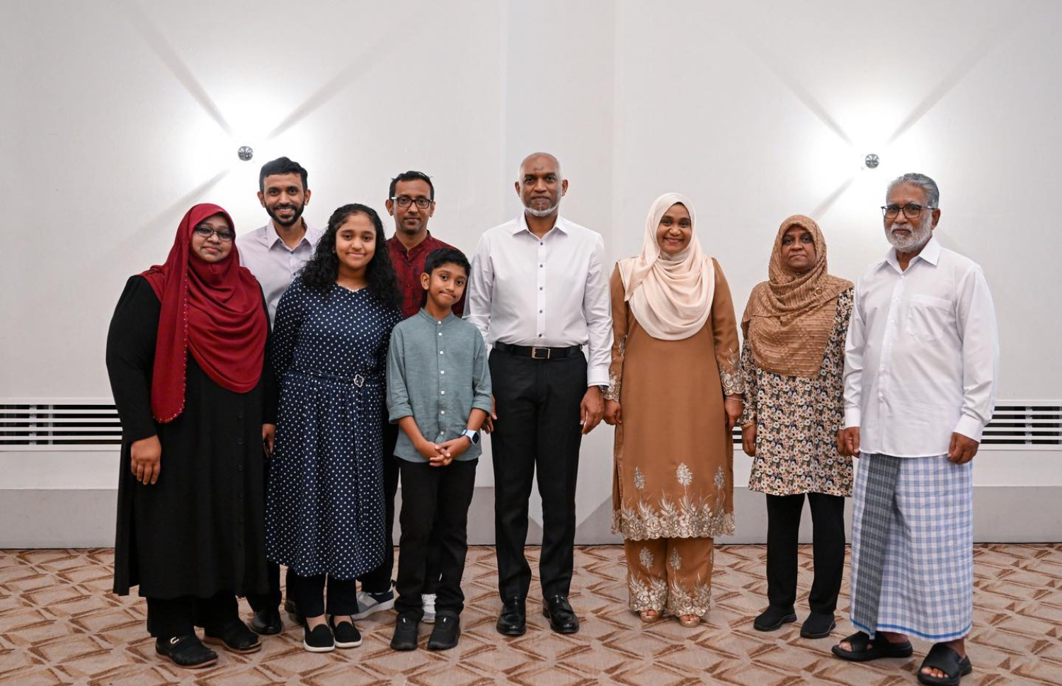 ސިންގަޕޫރުގައި ދިރިއުޅޭ އާއިލާއެެއްގެ ބަޔަކާ އެކު ރައީސް މުއިއްޒުގެ ދެކަނބަލުން ފޮޓޯއެއް ނަންގަވަނީ.---ފޮޓޯ: ރައީސް އޮފީސް