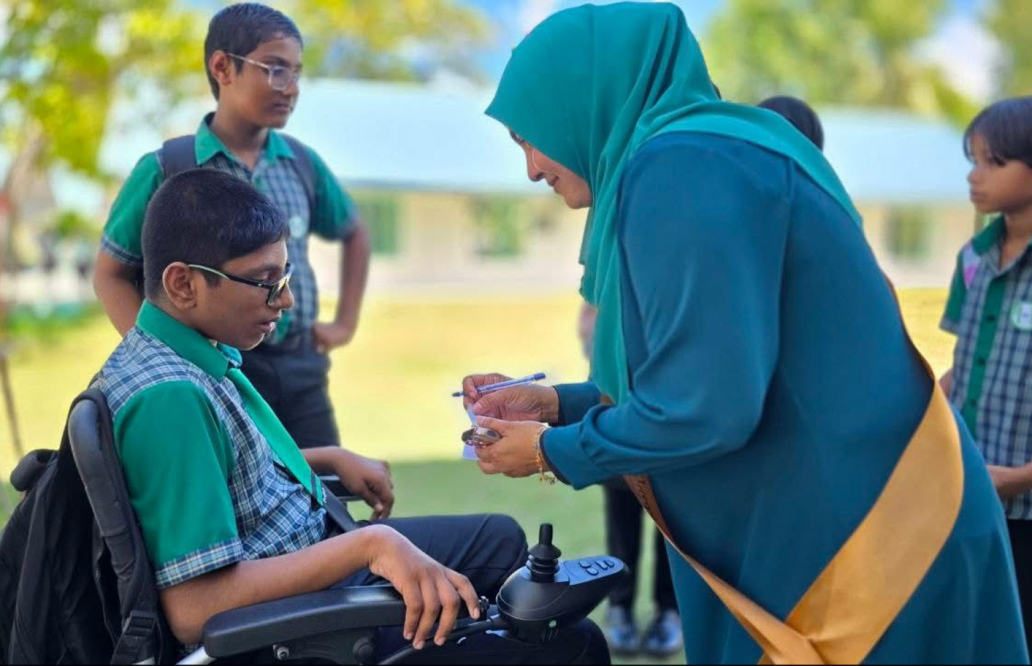 ސ. އަތޮޅު މަދަރުސާގައި 16 އަހަރު މަސައްކަތް ކުރެއްވި ޕްރިންސިޕަލް އައިމިނަތު ޒީނިޔާއަށް އެ ސްކޫލުން ދިން ފެއާވެލްގައި ދަރިވަރުންތަކަކާއެކު.-- ފޮޓޯ: ސ. އަތޮޅު މަދަރުސާ