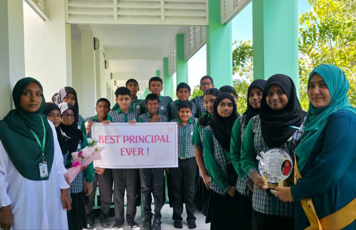 ސ. އަތޮޅު މަދަރުސާގައި 16 އަހަރު މަސައްކަތް ކުރެއްވި ޕްރިންސިޕަލް އައިމިނަތު ޒީނިޔާއަށް އެ ސްކޫލުން ދިން ފެއާވެލްގައި ދަރިވަރުންތަކަކާއެކު.-- ފޮޓޯ: ސ. އަތޮޅު މަދަރުސާ