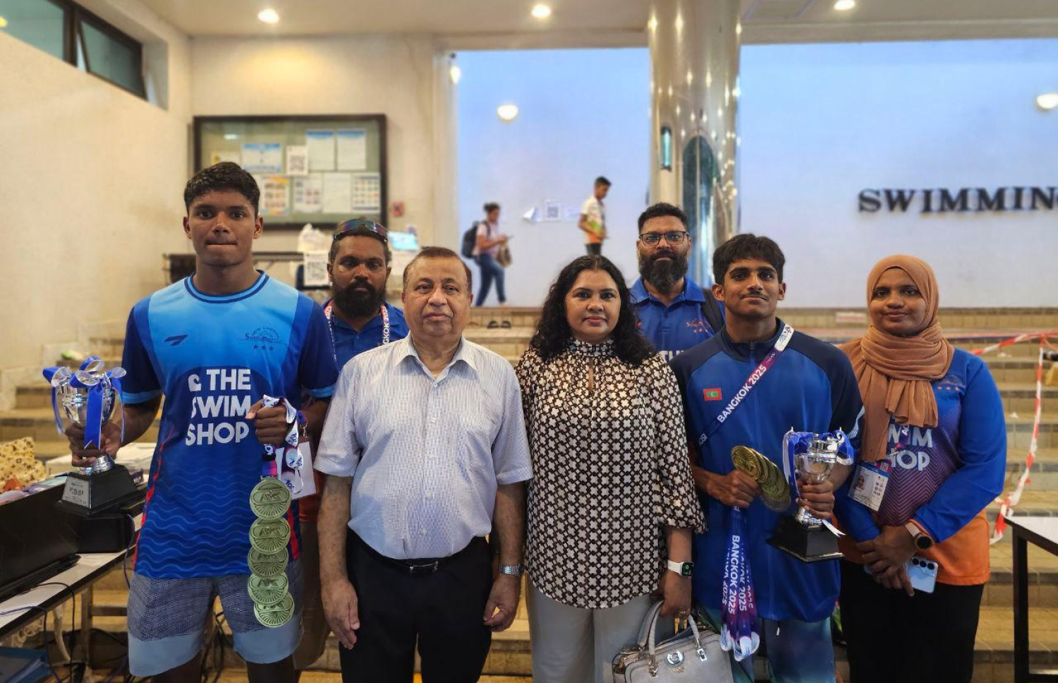 ތައިލެންޑުގެ ވެރިރަށް ބެންކޮކްގައި ކުރަައަށްދާ އޭޝިއަން އޯޕަން ސްކޫލް އިންވިޓޭޝަނަލް ޝޯޓްކޯސް މުބާރާތުގައި ބައިވެރިވި ދިވެހި ފެތުންތެރިންނާއި އެކު ބެލެނިވެރިން.-- ފޮޓޯ: ނިއު ލެގޫންސް