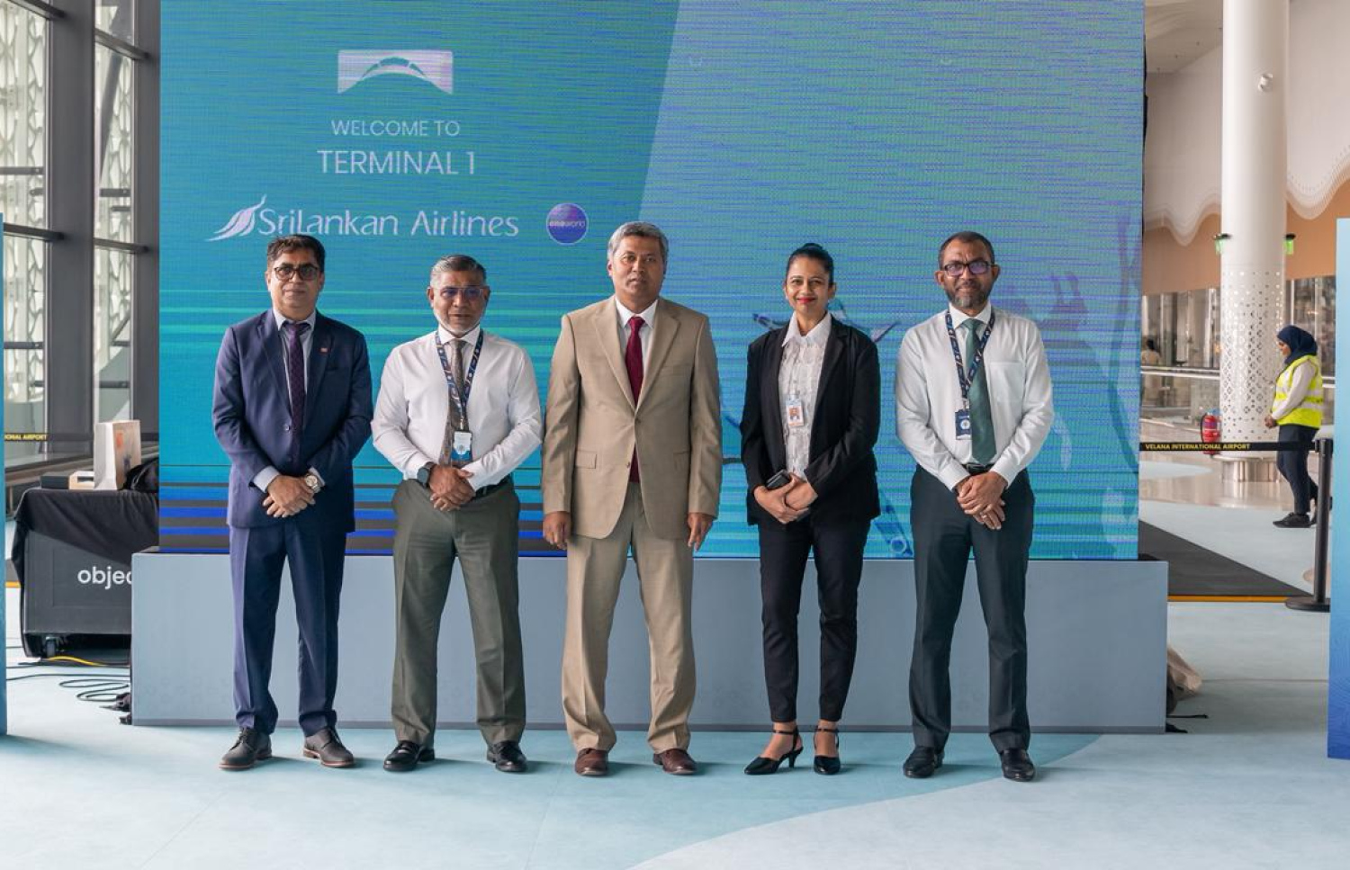 ސްރީ ލަންކަން އެއާލައިސުން ވީއައިއޭގެ އާ ޓާމިނަލުން މިއަދު ހިދުމަތް ދޭން ފެށުމާ ގުޅިގެން ބޭއްވި ރަސްމިއްުޔާތުގައި ރާއްޖޭގައި ހުންނަވާ ލަންކާގެ ސަފީރު މުހައްމަދު ރިޒްވީ ހަސަނާއި އެމްއޭސީއެލްގެ އެމްޑީ ޝަރީފާއި ސްރީލަންކަންގެ ރާއްޖޭގެ އެޖެންޑު އޭސް ޓްރެވެލްސްގެ ވެރިޔާ ފިރާގު އަދި އެހެން ބައެއް އިސް އޮފިޝަލުން.---ފޮޓޯ: އެމްއޭސީއެލް