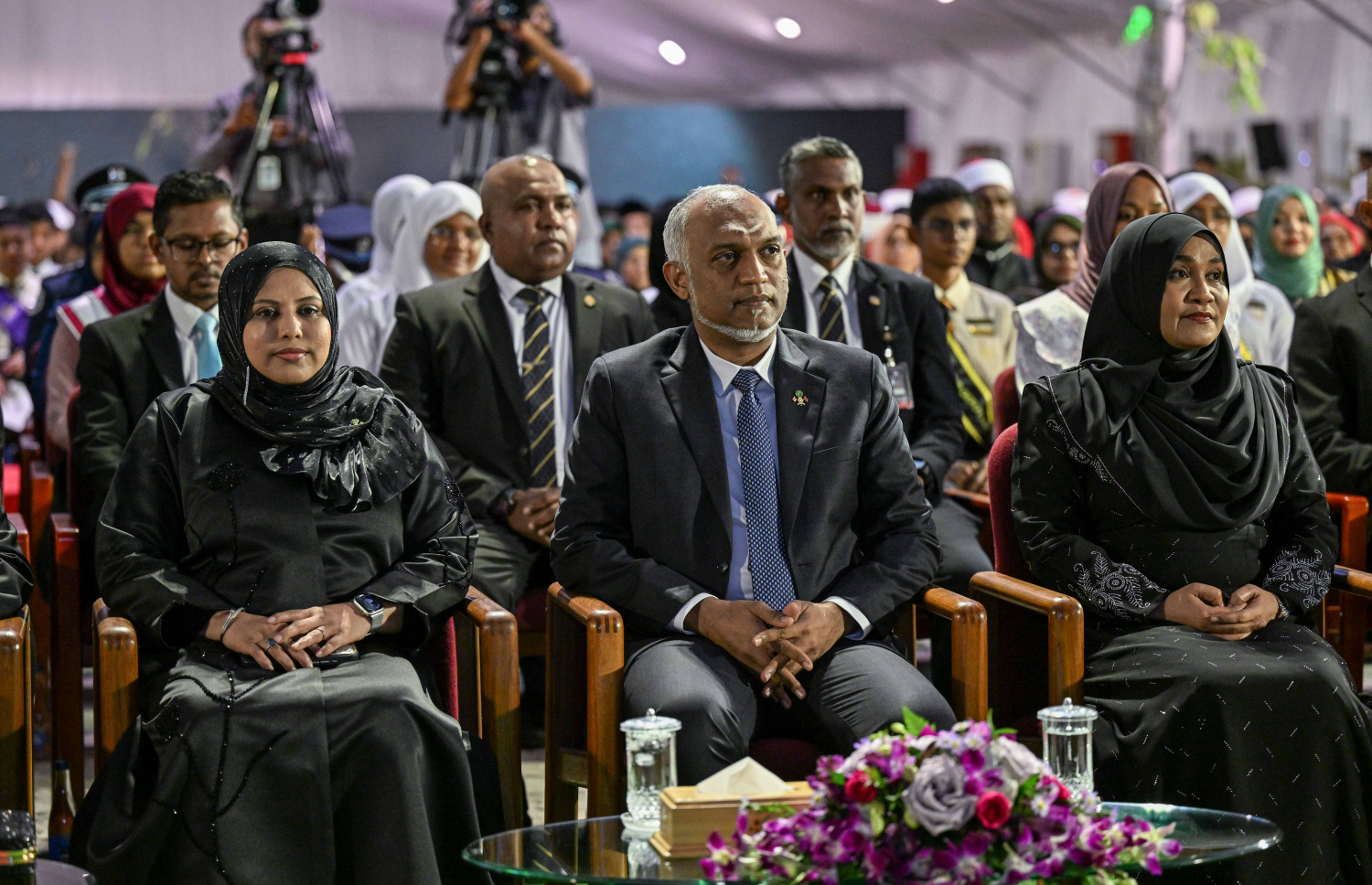 ރާއްޖެ އިސްލާމްވިތާ 900 އަހަރު ފުރުން ފާހަގަކުރުމަށް ބޭއްވި ޖަލްސާ އަށް ރައީސް ޑރ. މުހައްމަދު މުއިއްޒުގެ ދެކަނބަލުން ބައިވެރިވެ ވަޑައިގަންނަވަނީ އަދި އަރިހުގައި ފަންނާއި ސަގާފަތާއި ތަރިކައާ ބެހޭ މިނިސްޓަރު ހީނާ ވަލީދު.--- ފޮޓޯ: ރައީސް އޮފީސް